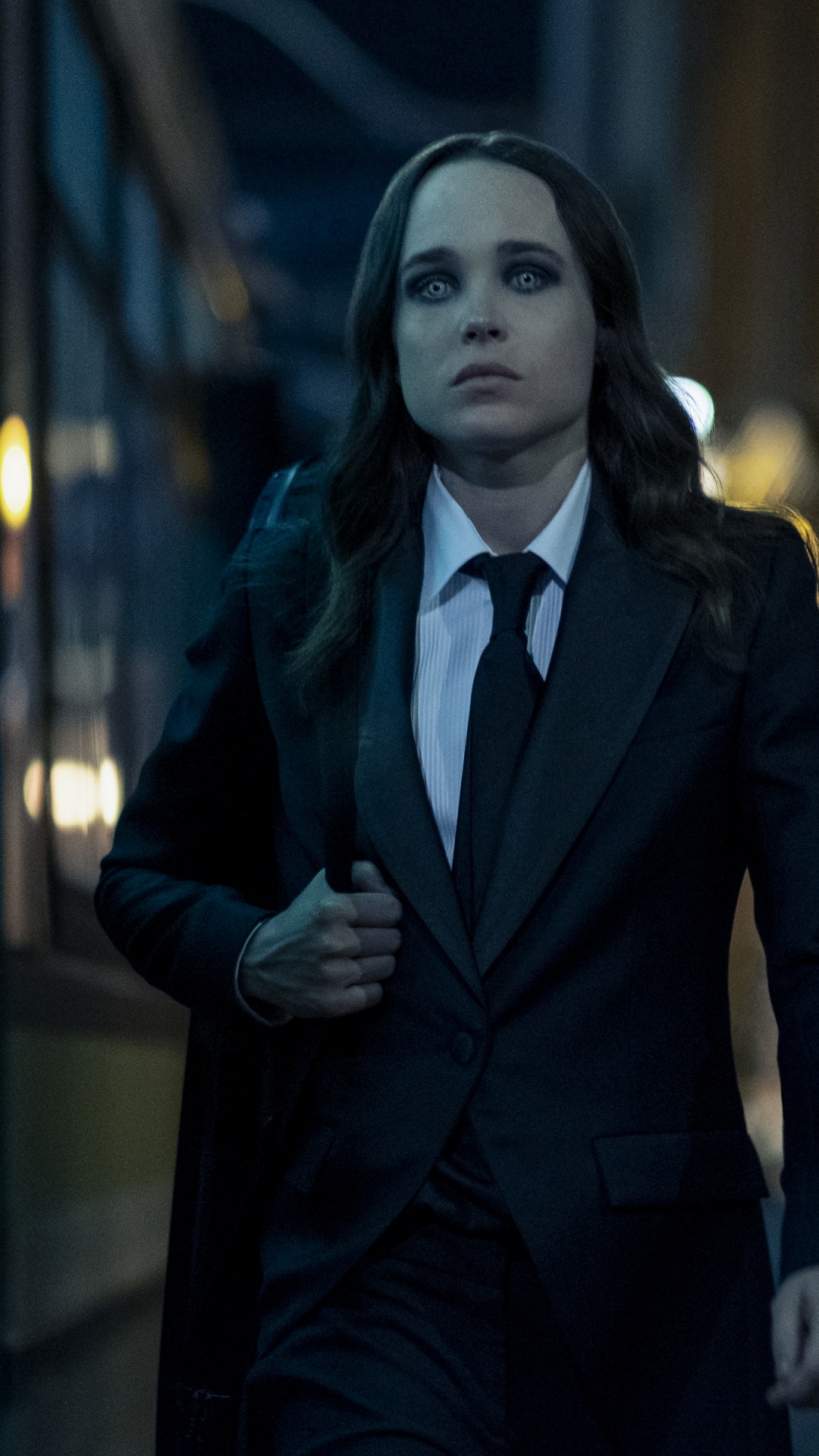 Woman in Black Coat Standing Near Glass Window. Wallpaper in 1080x1920 Resolution