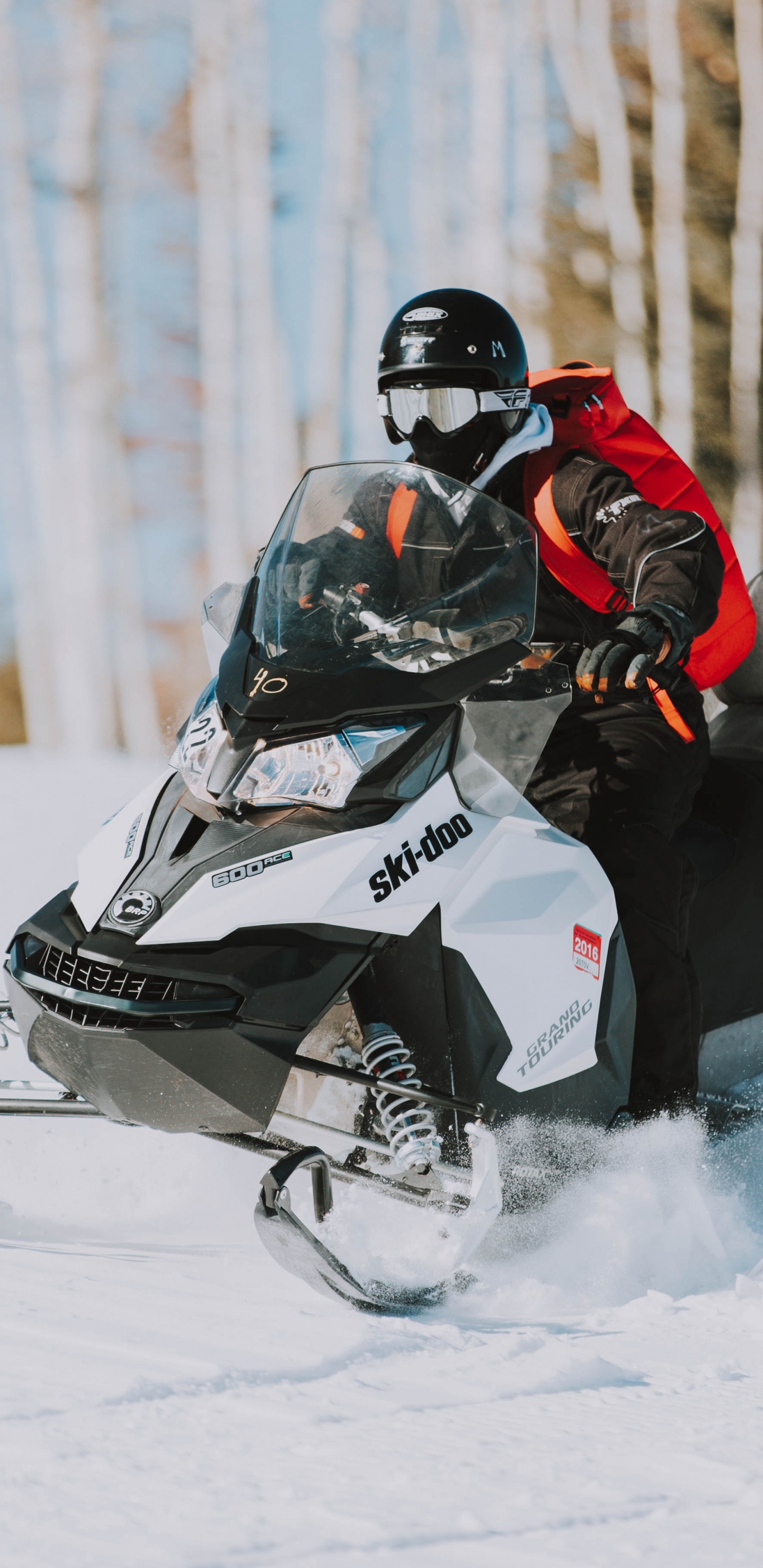 Person Riding Black and White Snow Mobile. Wallpaper in 1440x2960 Resolution
