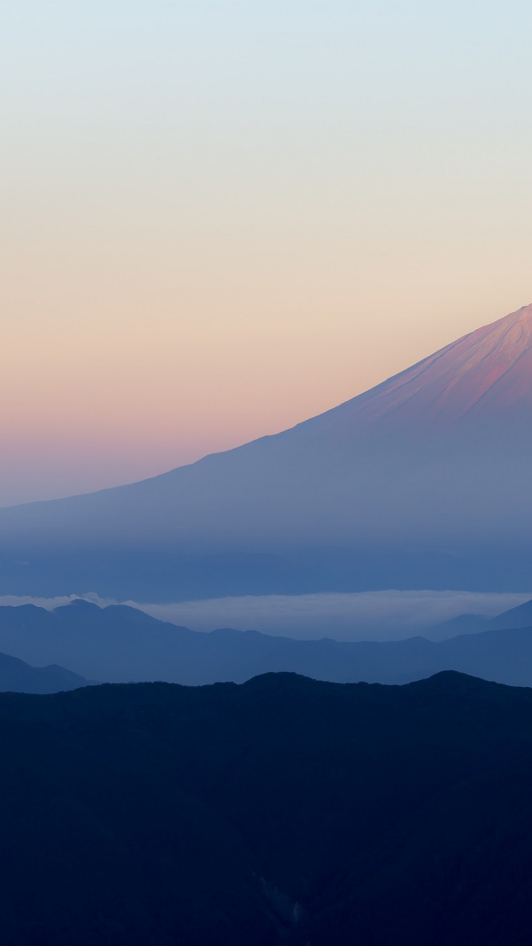 Mountain Ranges Covered in Clouds. Wallpaper in 750x1334 Resolution