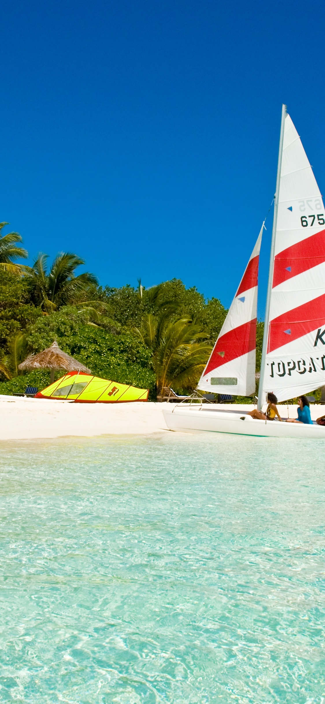 Red White and Blue Sail Boat on Sea Shore During Daytime. Wallpaper in 1125x2436 Resolution