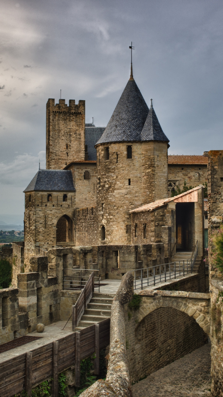 Gray Concrete Castle Near Green Trees Under Cloudy Sky During Daytime. Wallpaper in 750x1334 Resolution