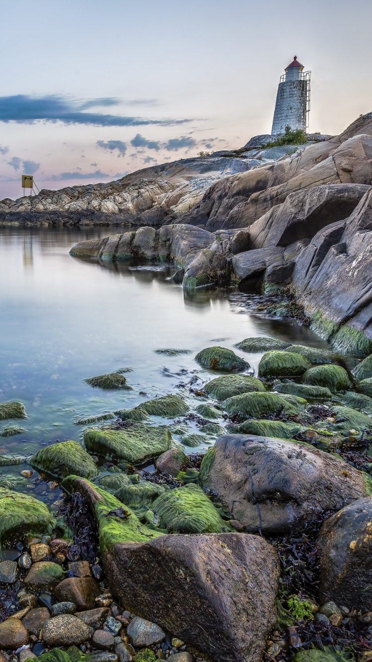 White Lighthouse on Rocky Shore During Daytime. Wallpaper in 750x1334 Resolution