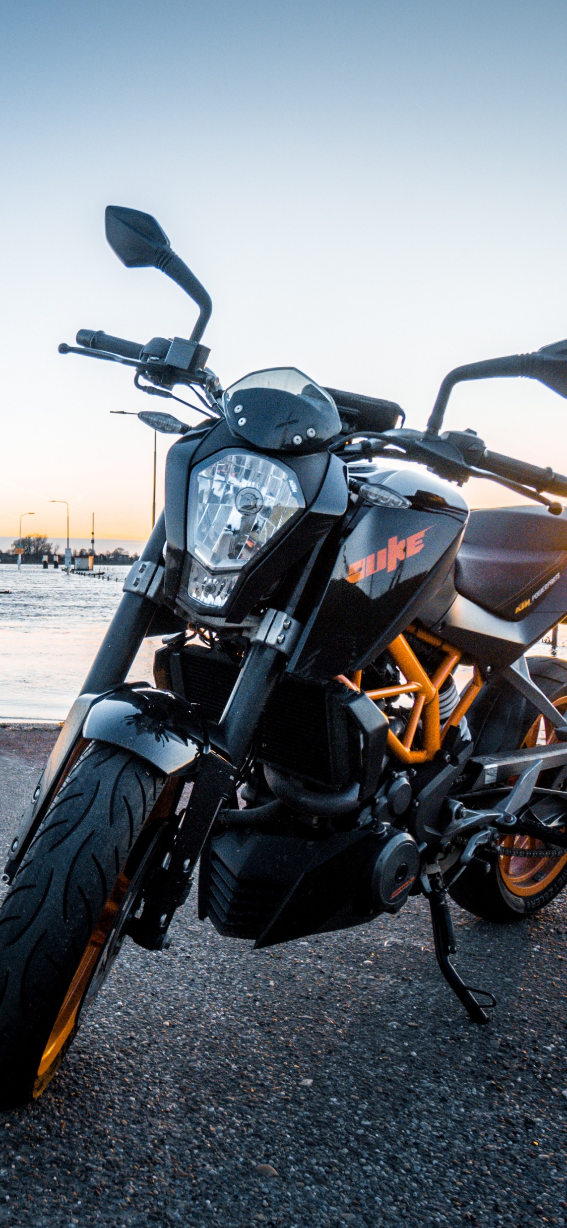 Black Motorcycle on Gray Asphalt Road During Daytime. Wallpaper in 1125x2436 Resolution