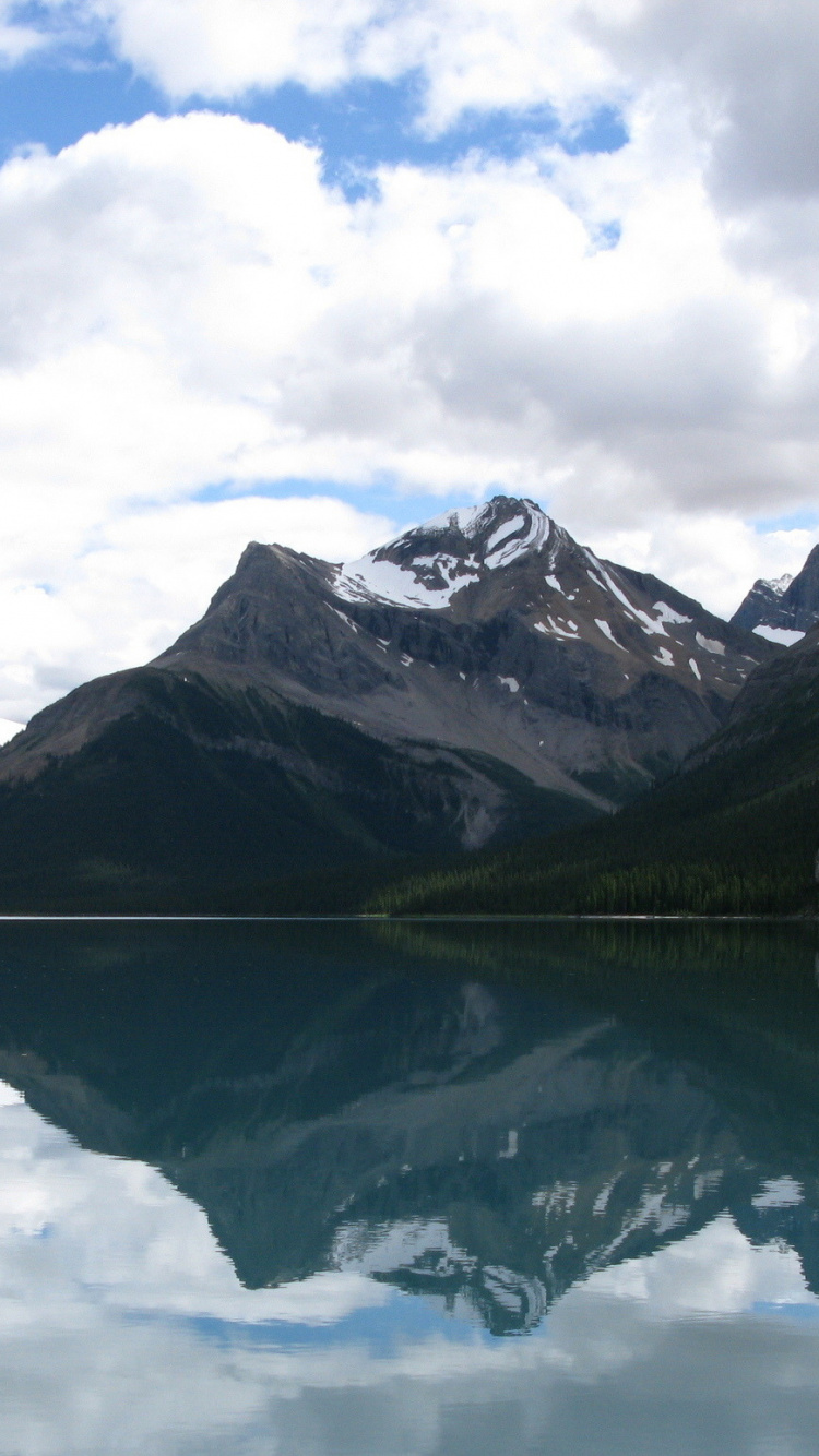 Lake Near Mountain Under White Clouds During Daytime. Wallpaper in 750x1334 Resolution