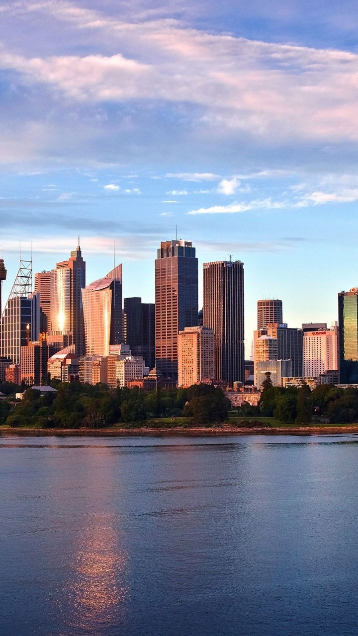 City Skyline Across Body of Water Under Cloudy Sky During Daytime. Wallpaper in 720x1280 Resolution