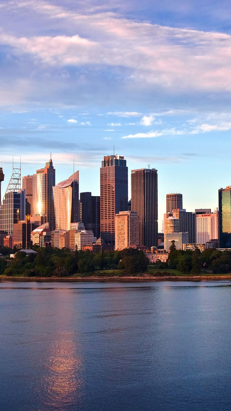 City Skyline Across Body of Water Under Cloudy Sky During Daytime. Wallpaper in 750x1334 Resolution