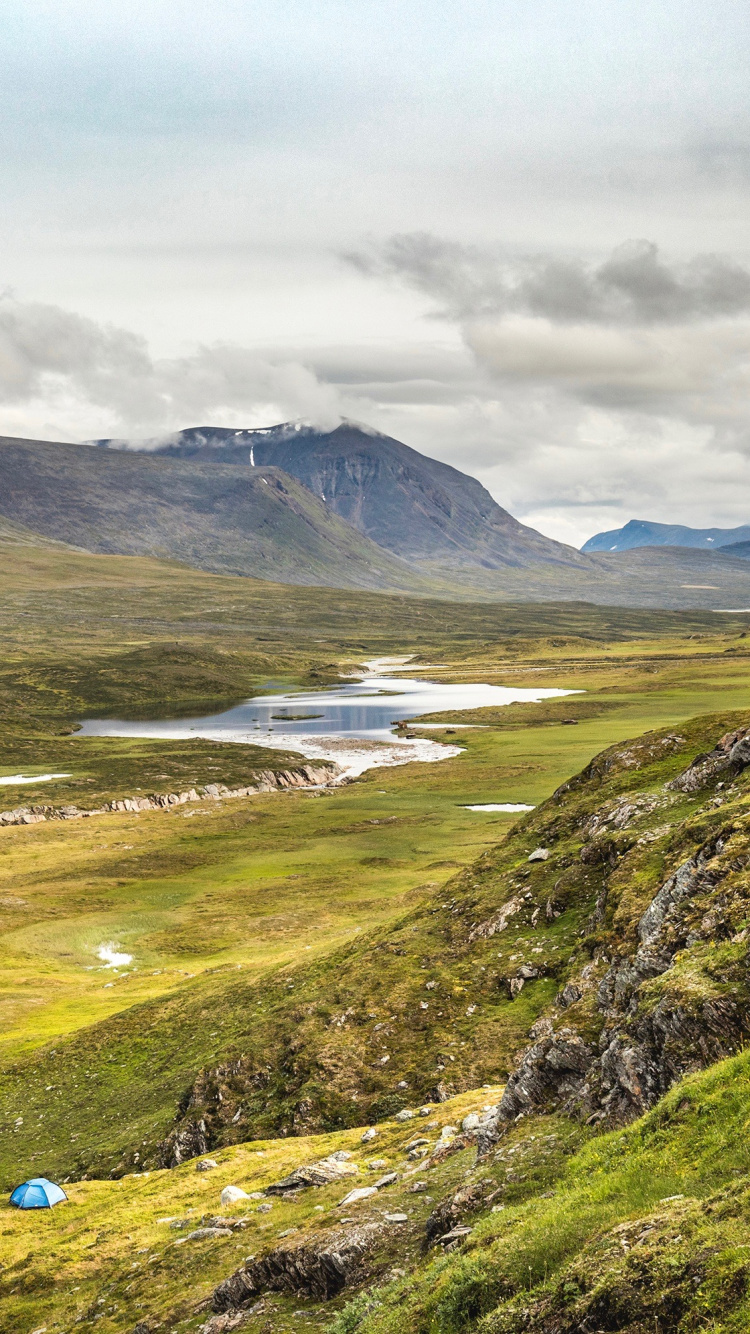 Green Grass Covered Mountain Under Cloudy Sky During Daytime. Wallpaper in 750x1334 Resolution