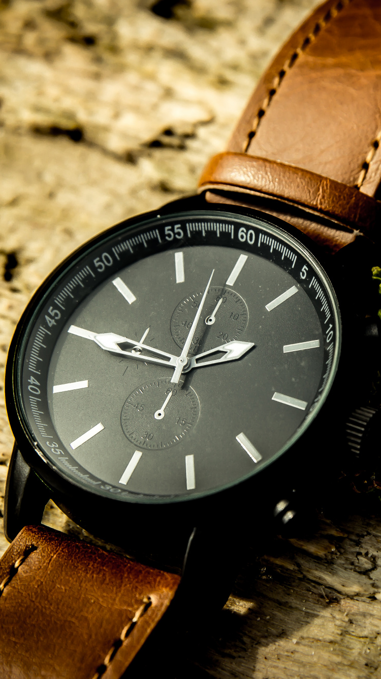 Brown Leather Strap Blue Round Analog Watch. Wallpaper in 750x1334 Resolution