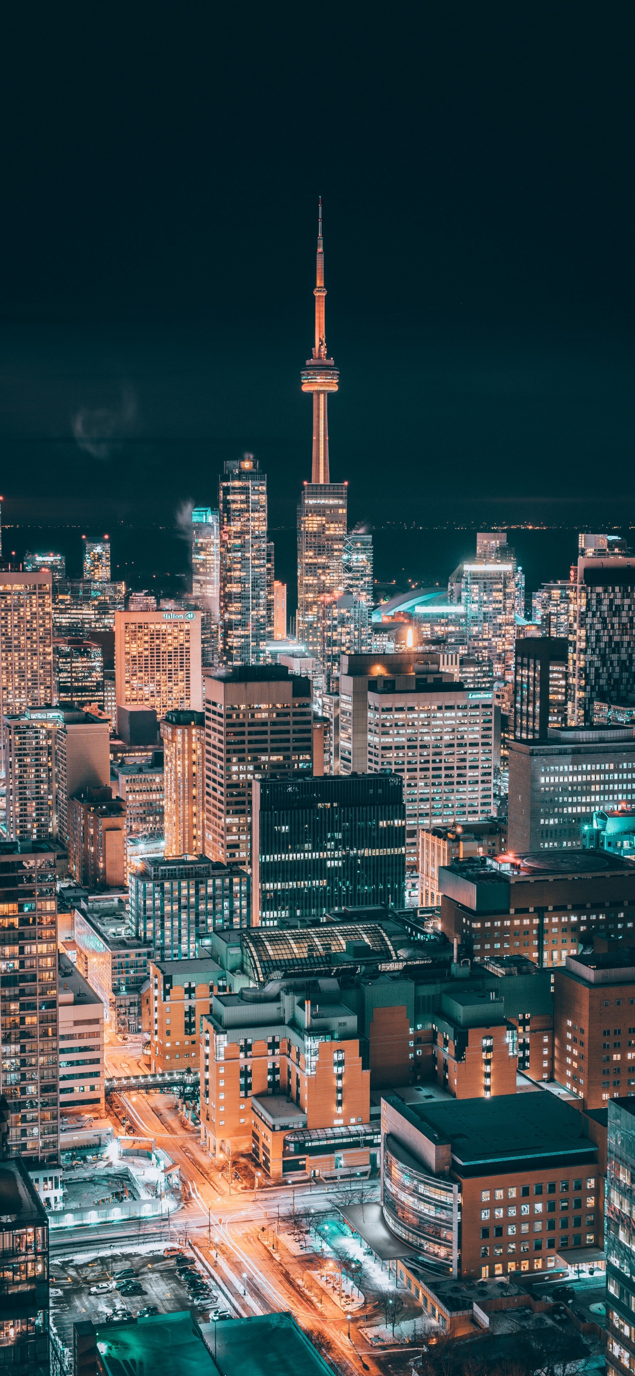 City With High Rise Buildings During Night Time. Wallpaper in 1242x2688 Resolution