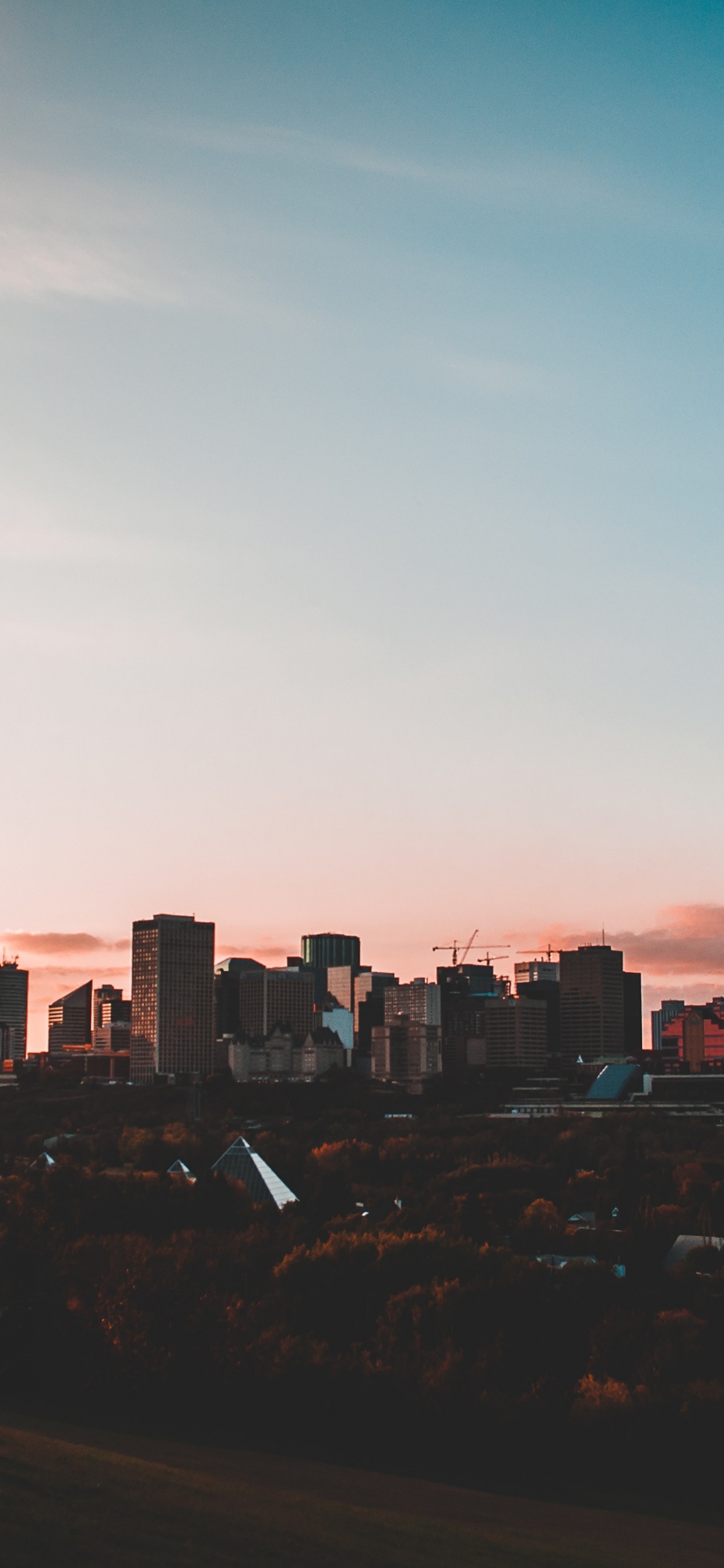 City Skyline Under Blue Sky During Sunset. Wallpaper in 1242x2688 Resolution