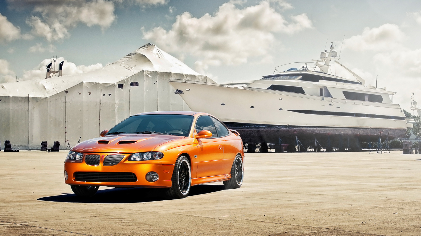 Orange Chevrolet Camaro on Snow Covered Field During Daytime. Wallpaper in 1366x768 Resolution