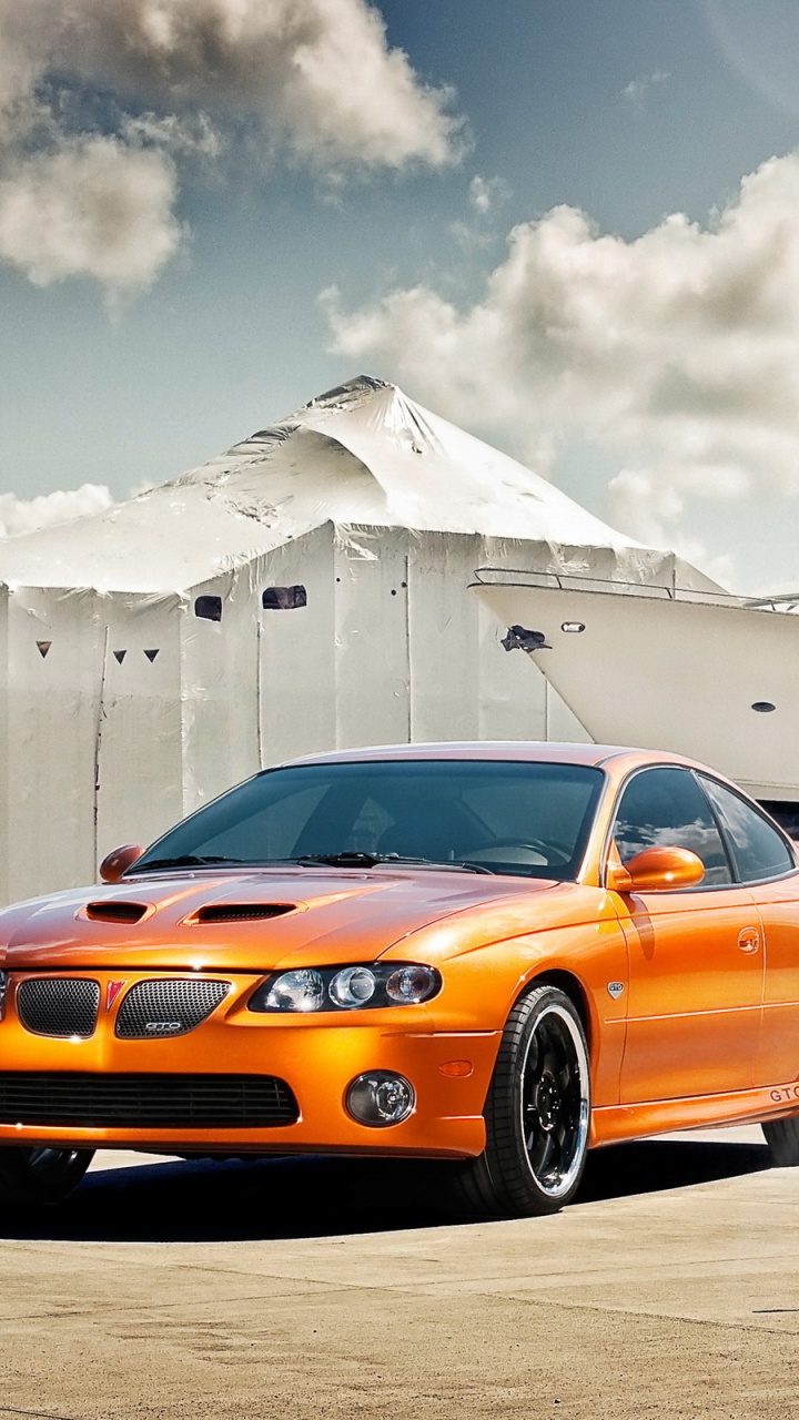 Orange Chevrolet Camaro on Snow Covered Field During Daytime. Wallpaper in 720x1280 Resolution