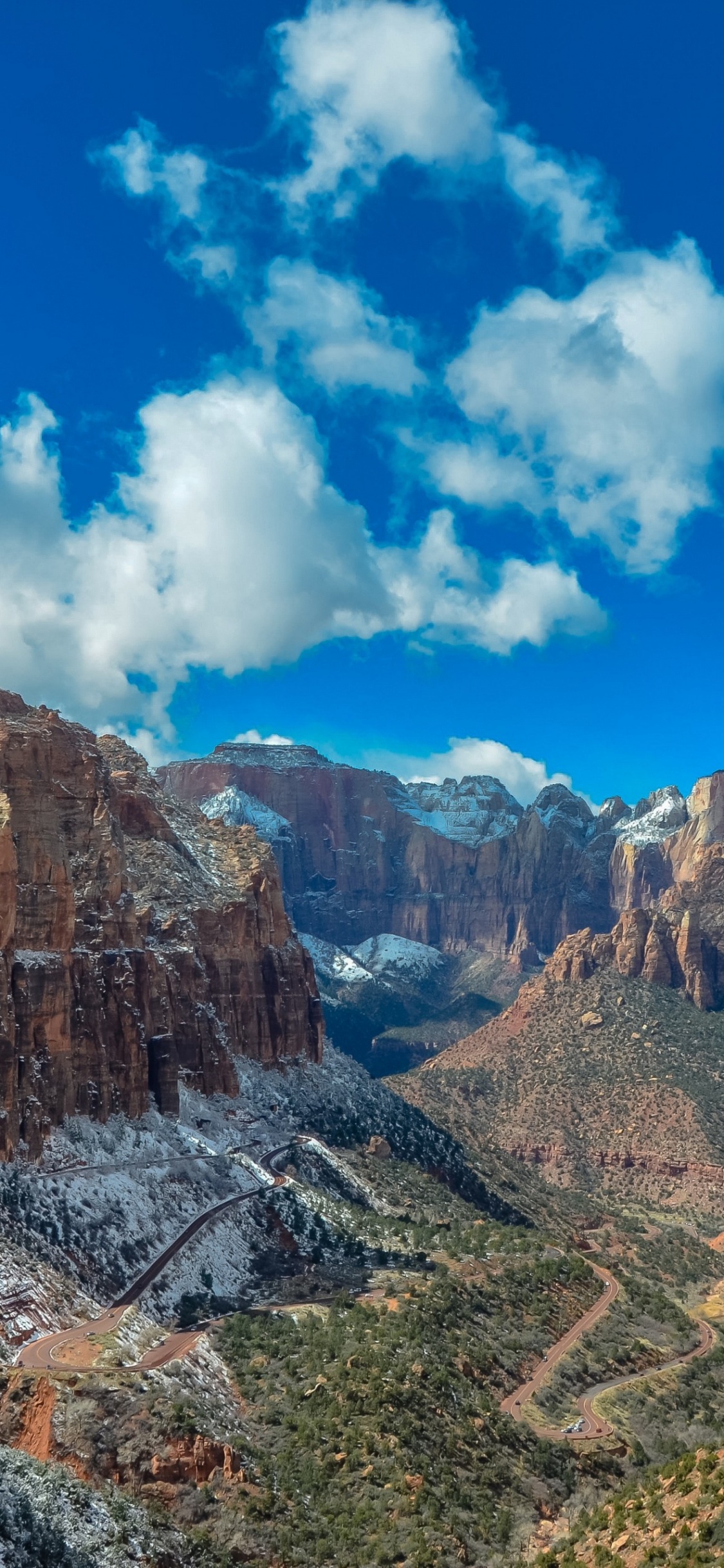 Brown Rocky Mountain Under Blue Sky During Daytime. Wallpaper in 1125x2436 Resolution