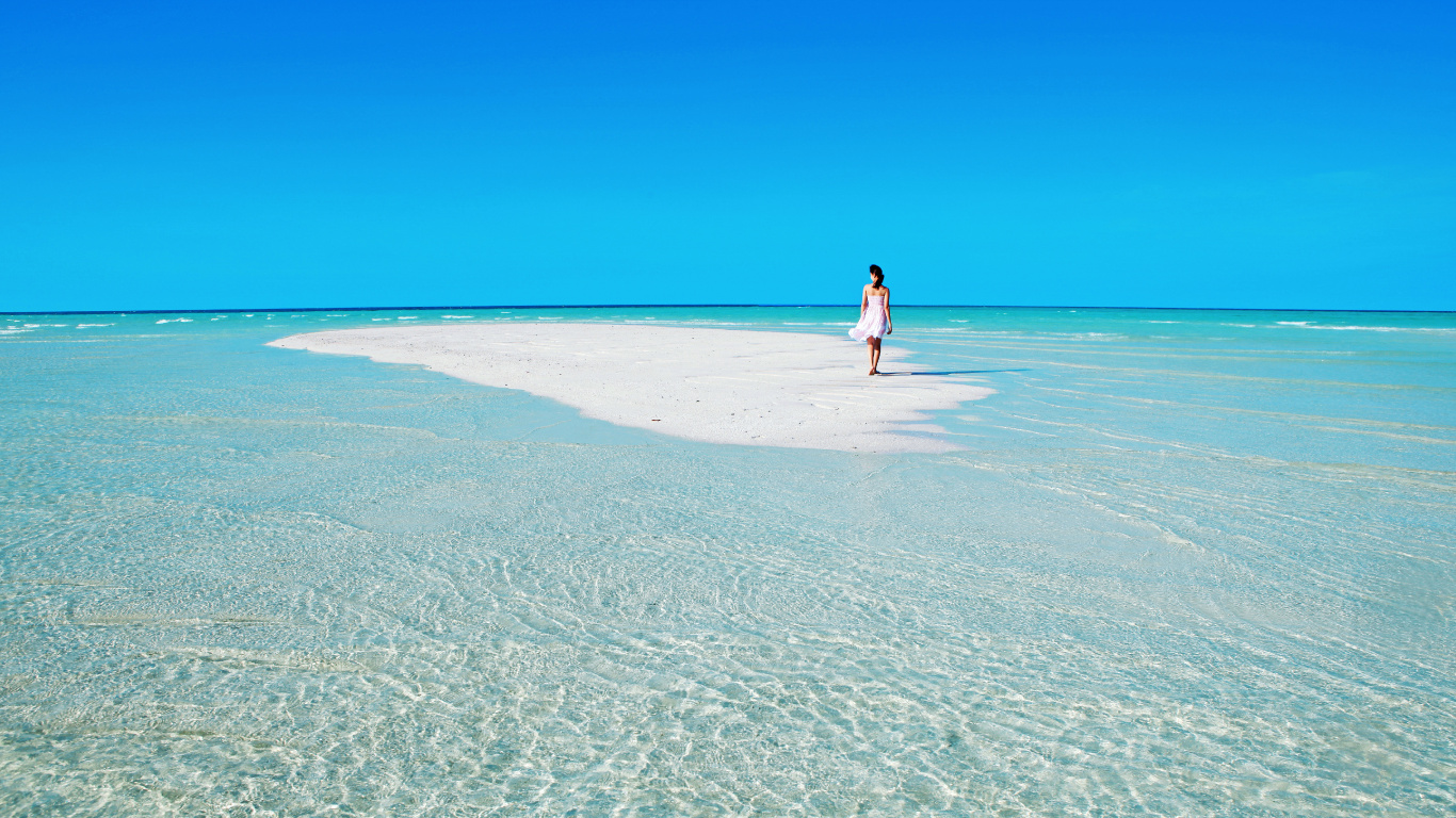 Woman in White Shirt Walking on Beach During Daytime. Wallpaper in 1366x768 Resolution