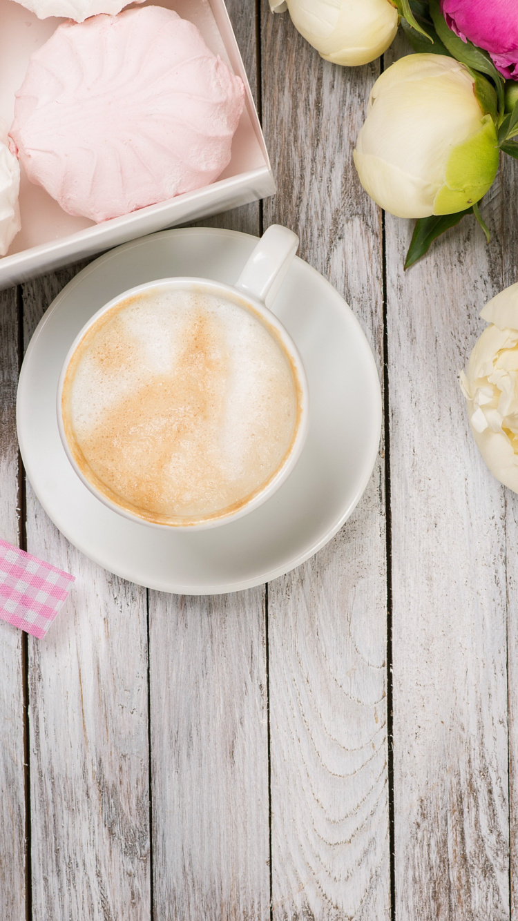 White Ceramic Cup With Brown Liquid Beside White and Purple Flower Bouquet. Wallpaper in 750x1334 Resolution