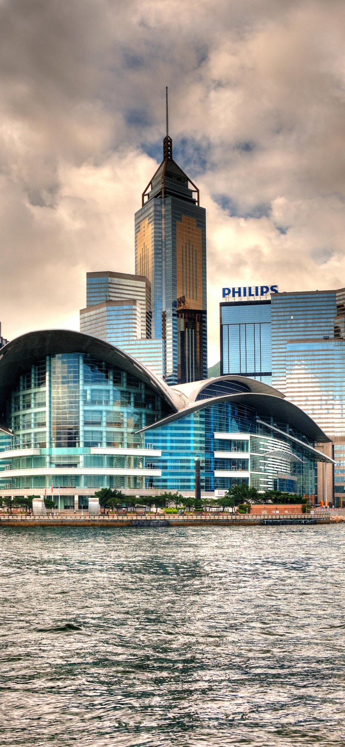 City Skyline Under Cloudy Sky During Daytime. Wallpaper in 1125x2436 Resolution