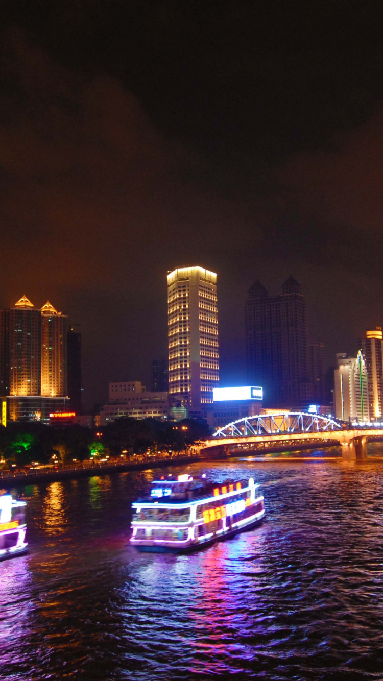 White and Blue Boat on Water Near City Buildings During Night Time. Wallpaper in 750x1334 Resolution