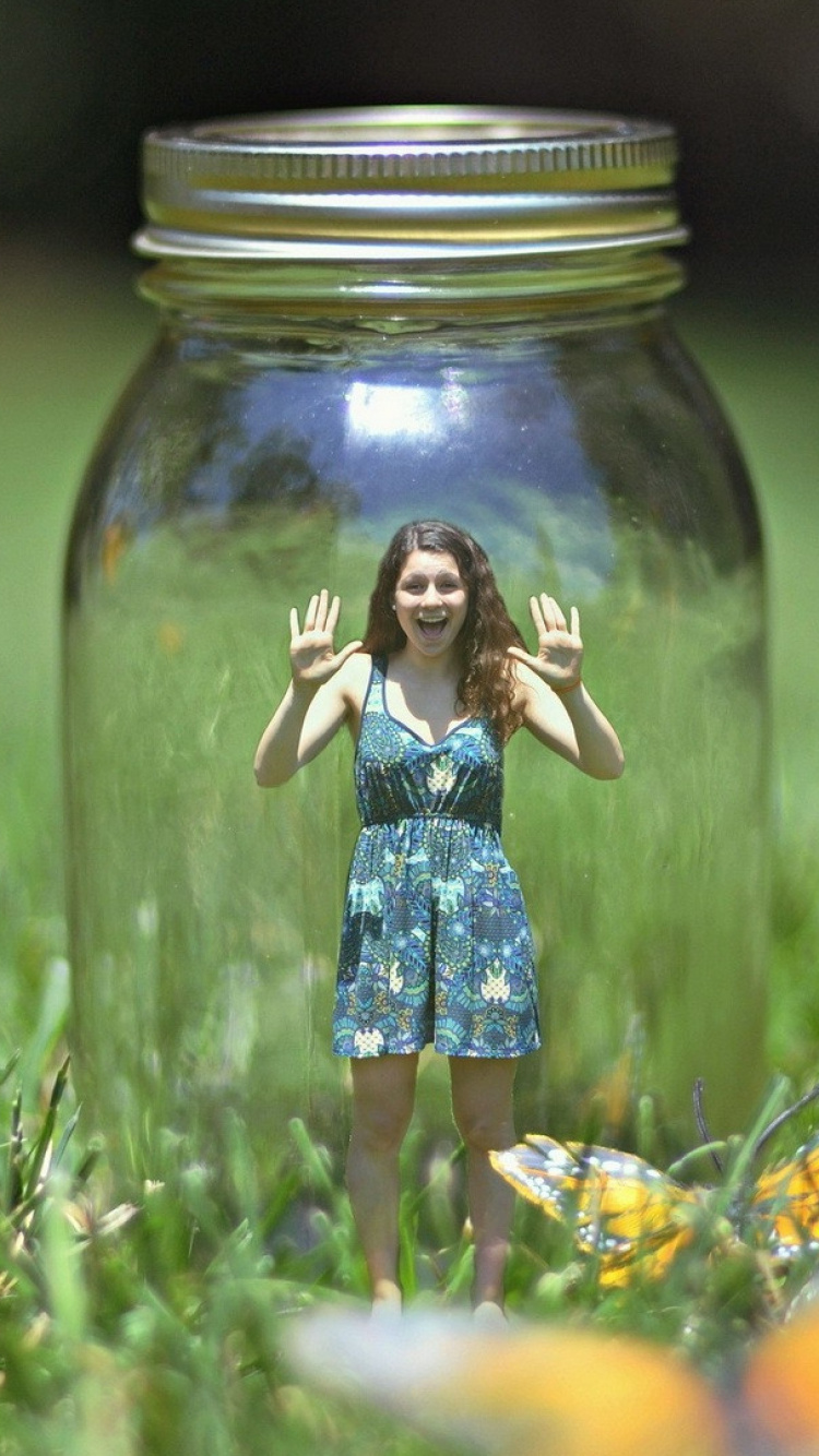 Girl in Blue Dress Standing on Green Grass Field. Wallpaper in 750x1334 Resolution