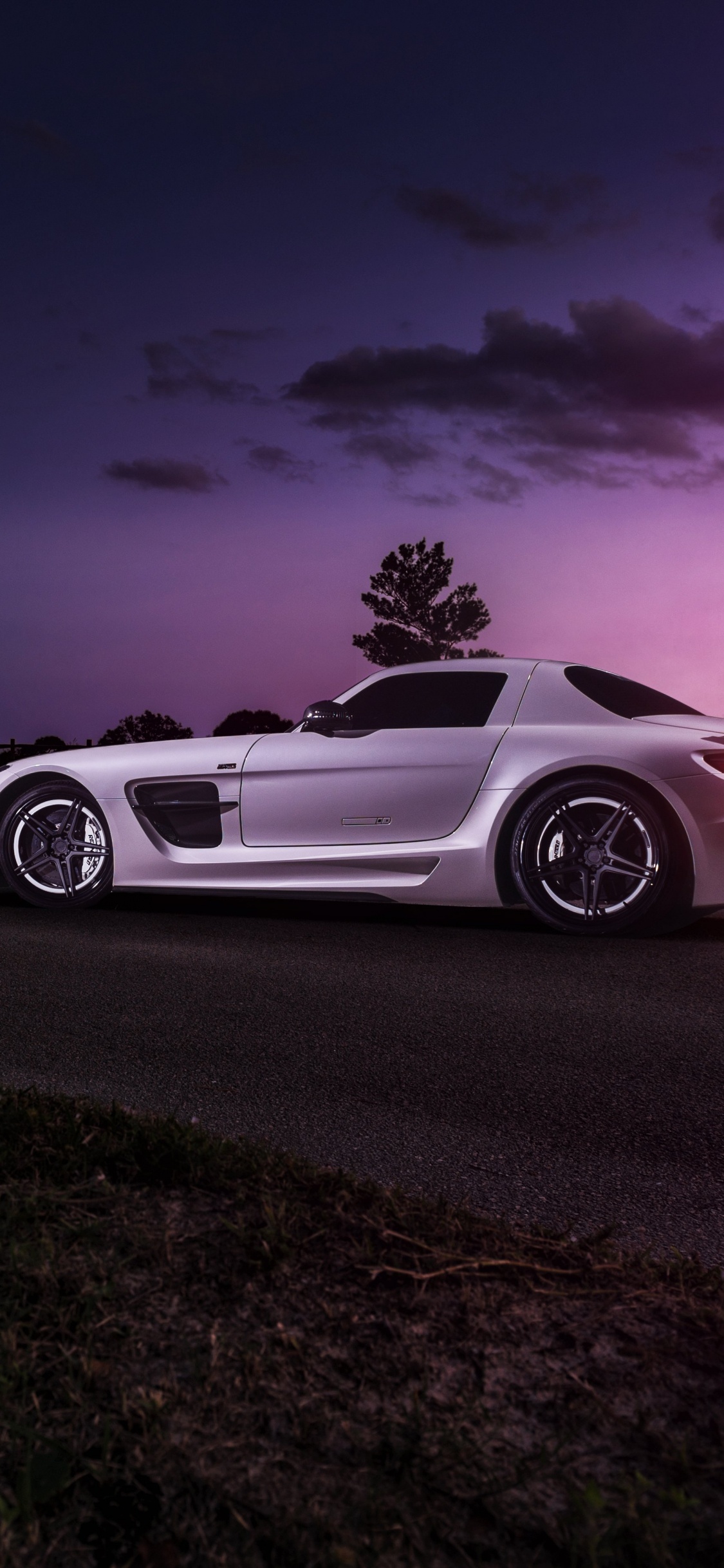 White Coupe on Gray Asphalt Road During Night Time. Wallpaper in 1125x2436 Resolution