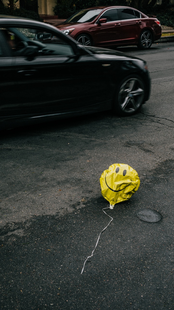 Yellow Balloon on Gray Asphalt Road. Wallpaper in 720x1280 Resolution