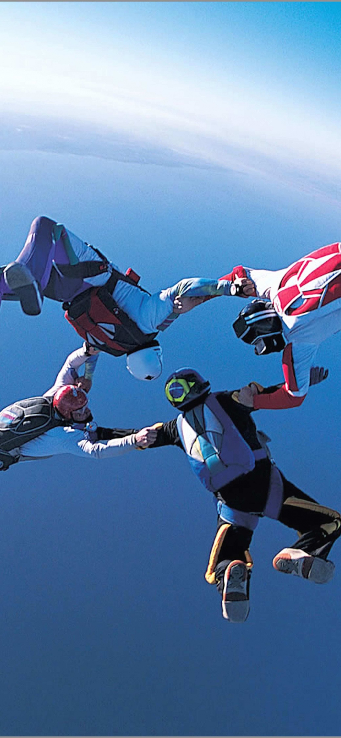 People in Blue and White Shirt and Pants Doing Sky Diving During Daytime. Wallpaper in 1125x2436 Resolution