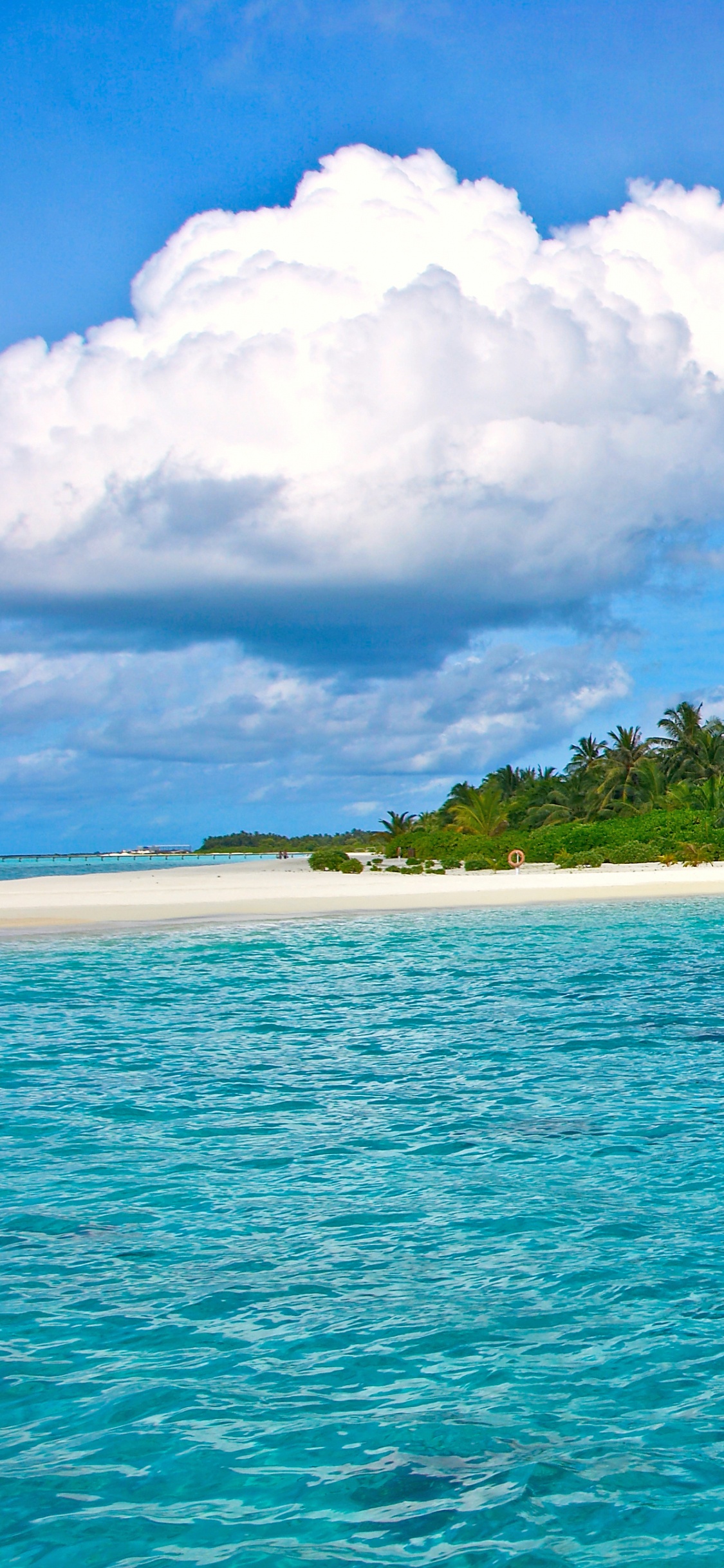 People in White and Green Boat on Blue Sea Under Blue and White Cloudy Sky During. Wallpaper in 1125x2436 Resolution