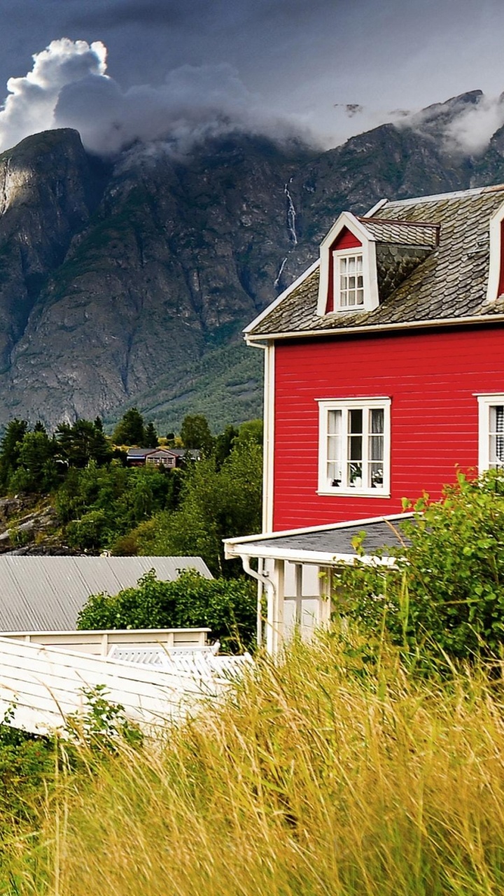 Red and White Wooden House Near Lake and Mountains Under Blue Sky During Daytime. Wallpaper in 720x1280 Resolution