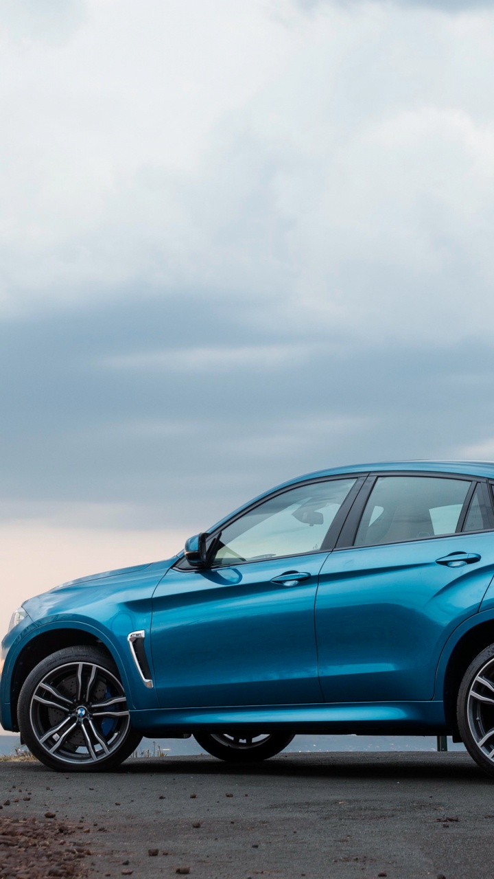 Blue Sedan on Brown Field Under White Clouds During Daytime. Wallpaper in 720x1280 Resolution