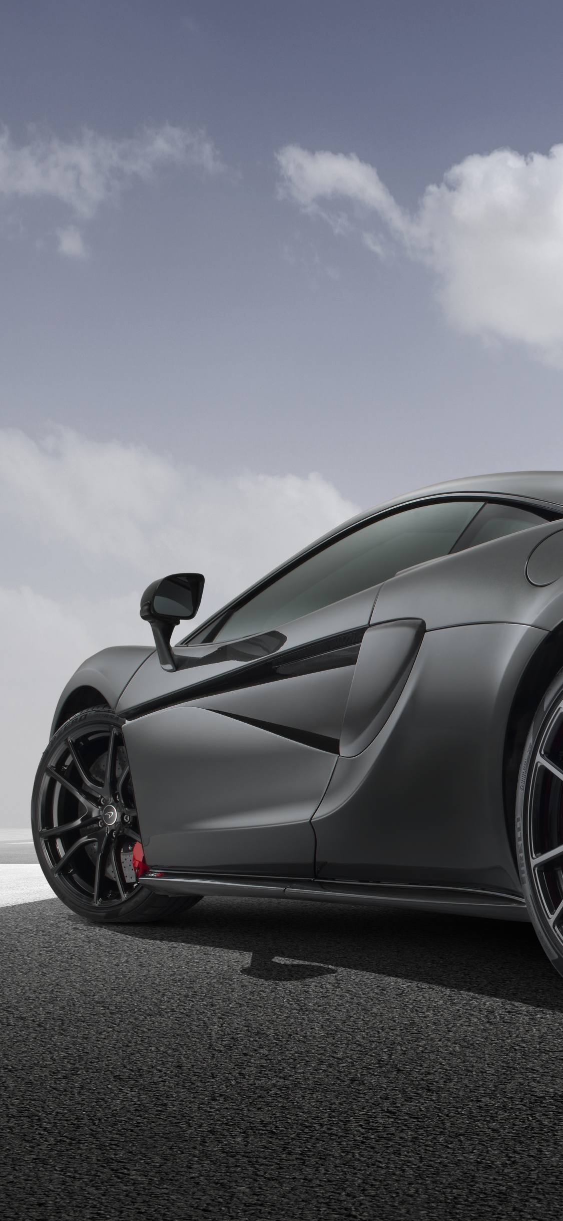 Black Porsche 911 on Road Under Blue Sky During Daytime. Wallpaper in 1125x2436 Resolution