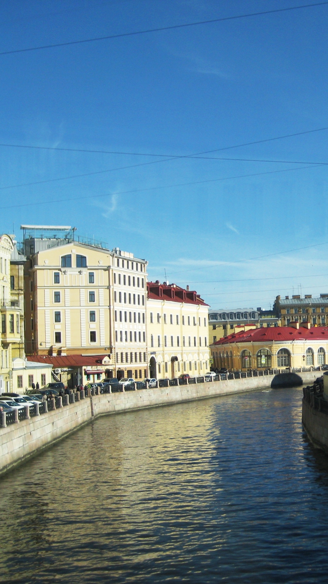 White and Brown Concrete Building Beside River Under Blue Sky During Daytime. Wallpaper in 1080x1920 Resolution