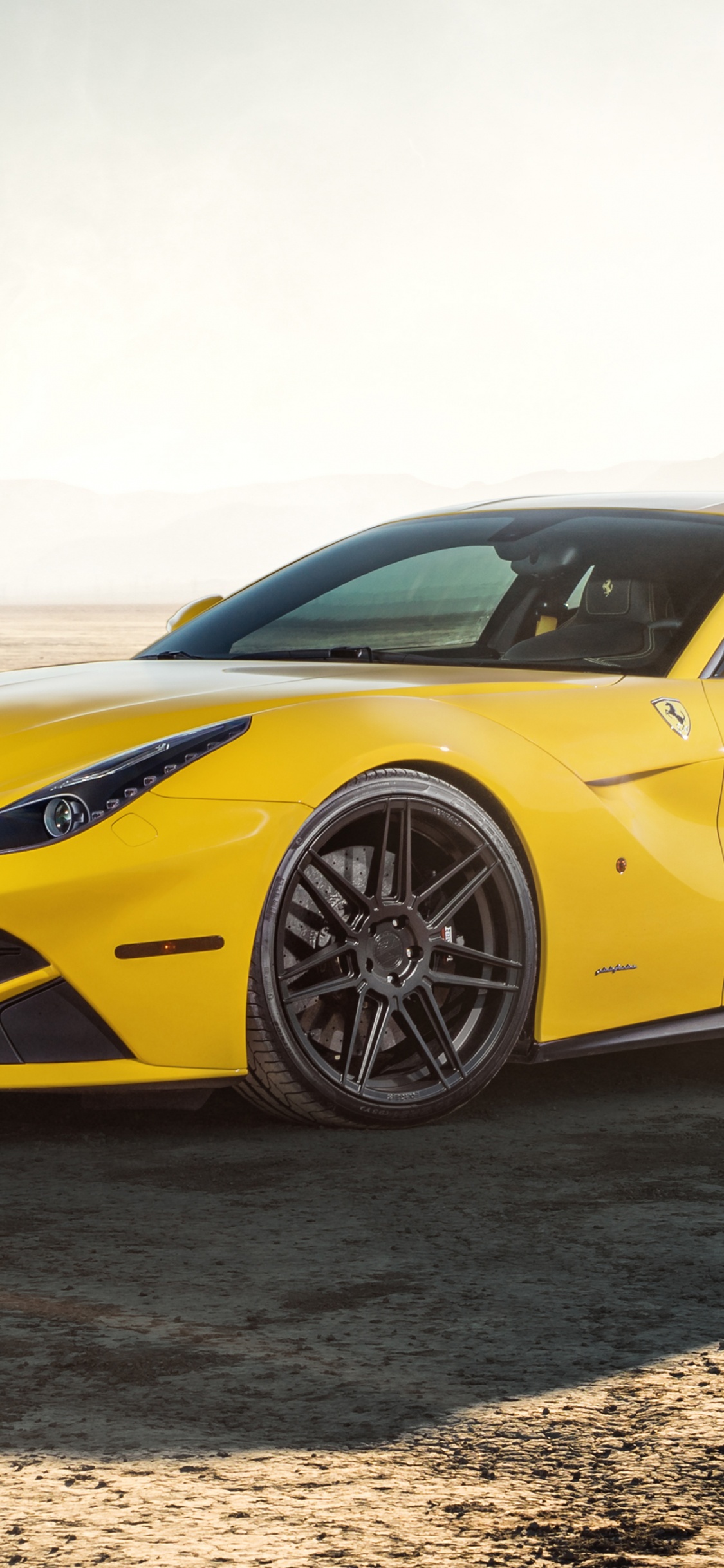 Gelber Porsche 911 Auf Braunem Sand Tagsüber. Wallpaper in 1125x2436 Resolution