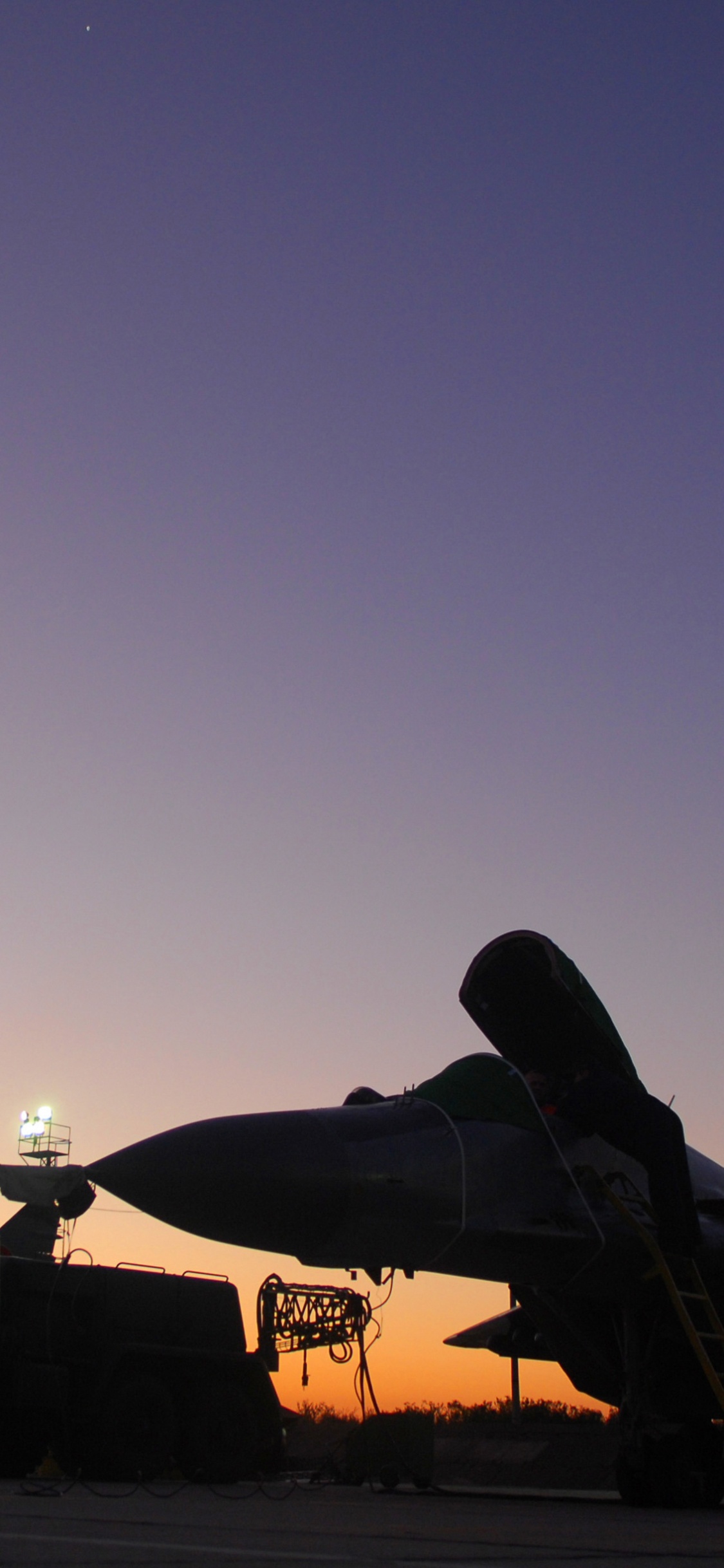 Avion de Chasse Noir et Jaune Dans le Ciel Pendant la Nuit. Wallpaper in 1125x2436 Resolution