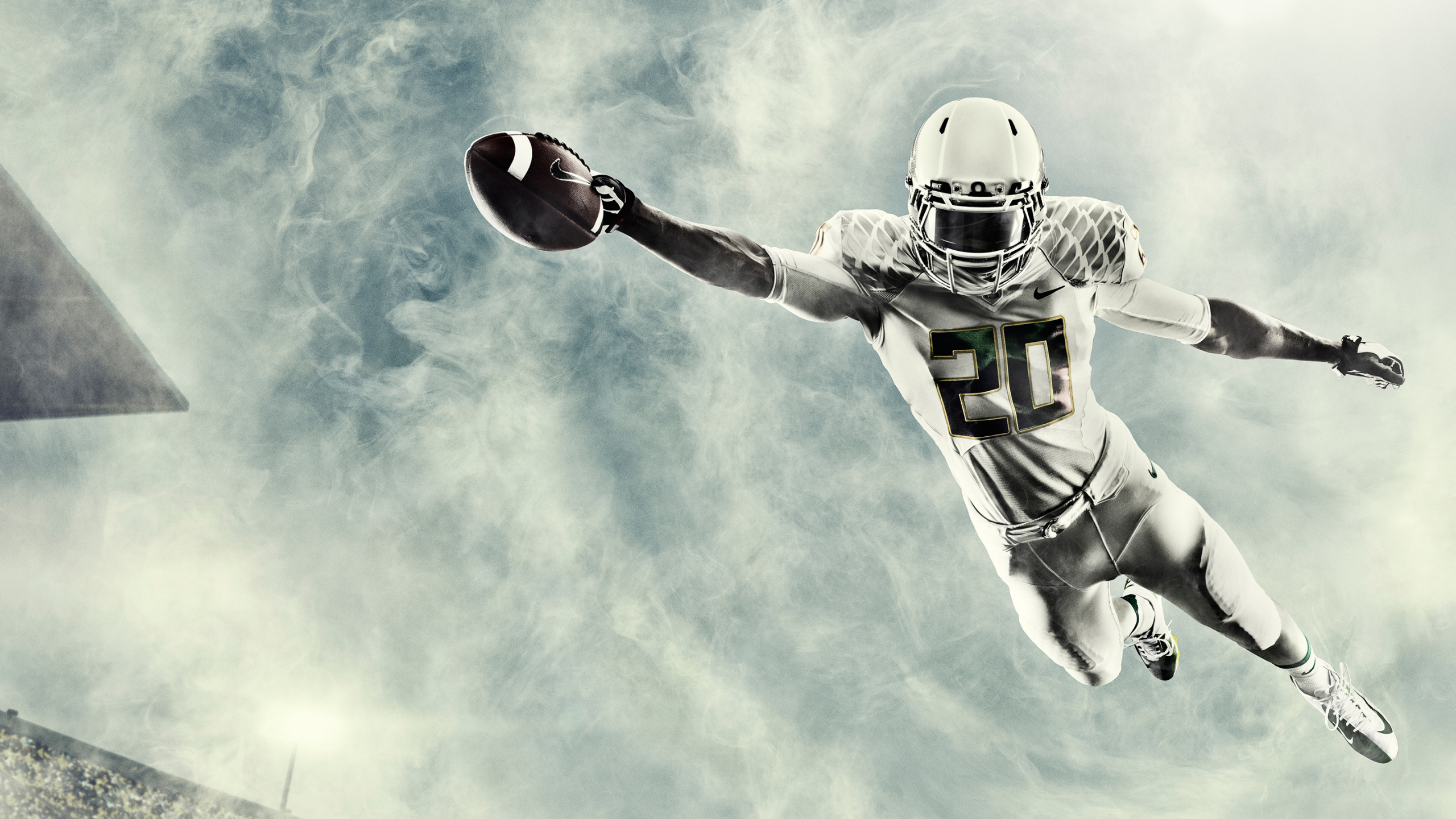 Joueur de Football en Maillot Vert et Blanc Tenant le Football Rouge. Wallpaper in 2560x1440 Resolution