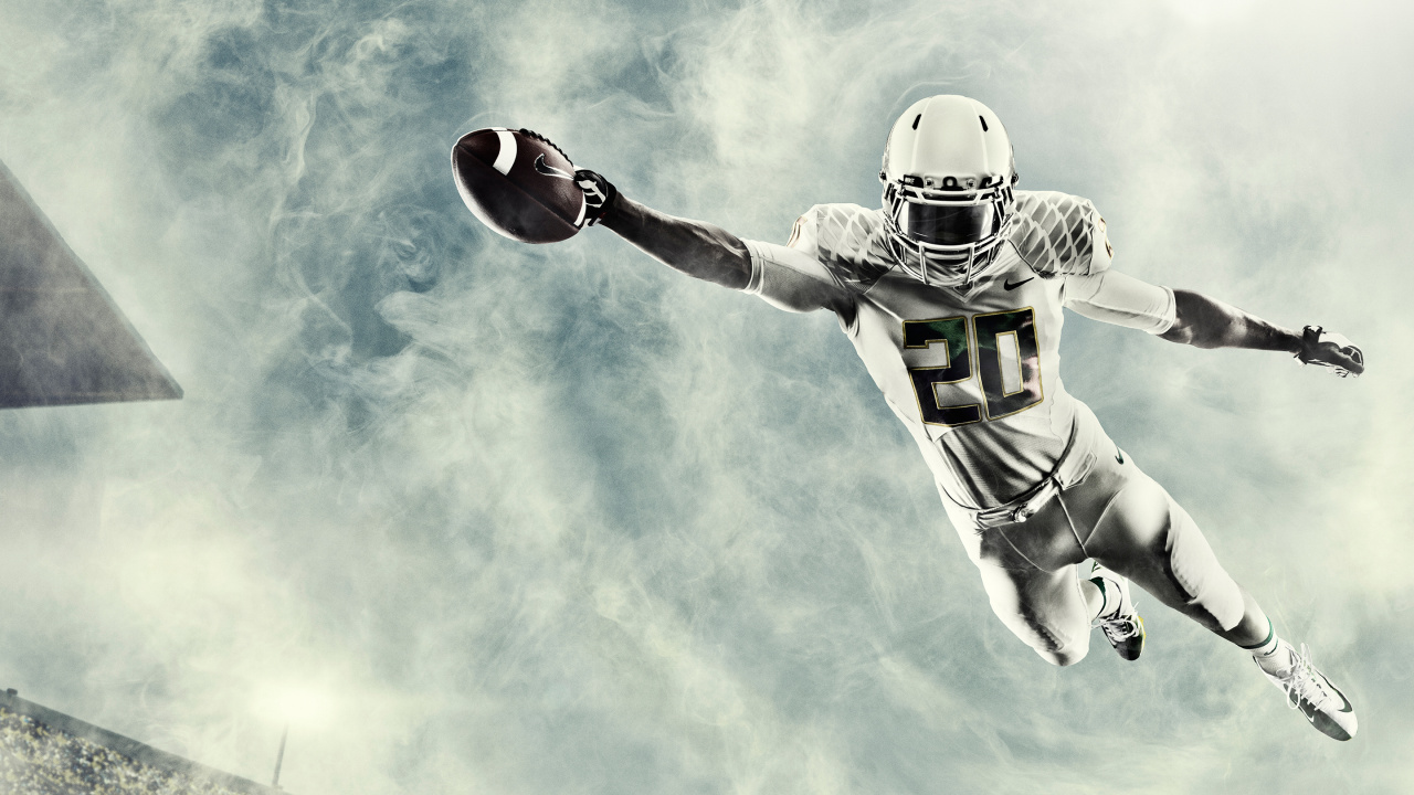 Football Player in Green and White Jersey Holding Red Football. Wallpaper in 1280x720 Resolution