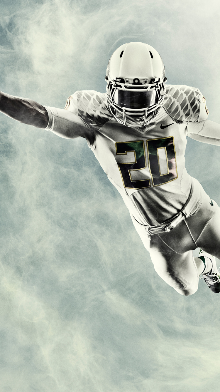 Football Player in Green and White Jersey Holding Red Football. Wallpaper in 750x1334 Resolution