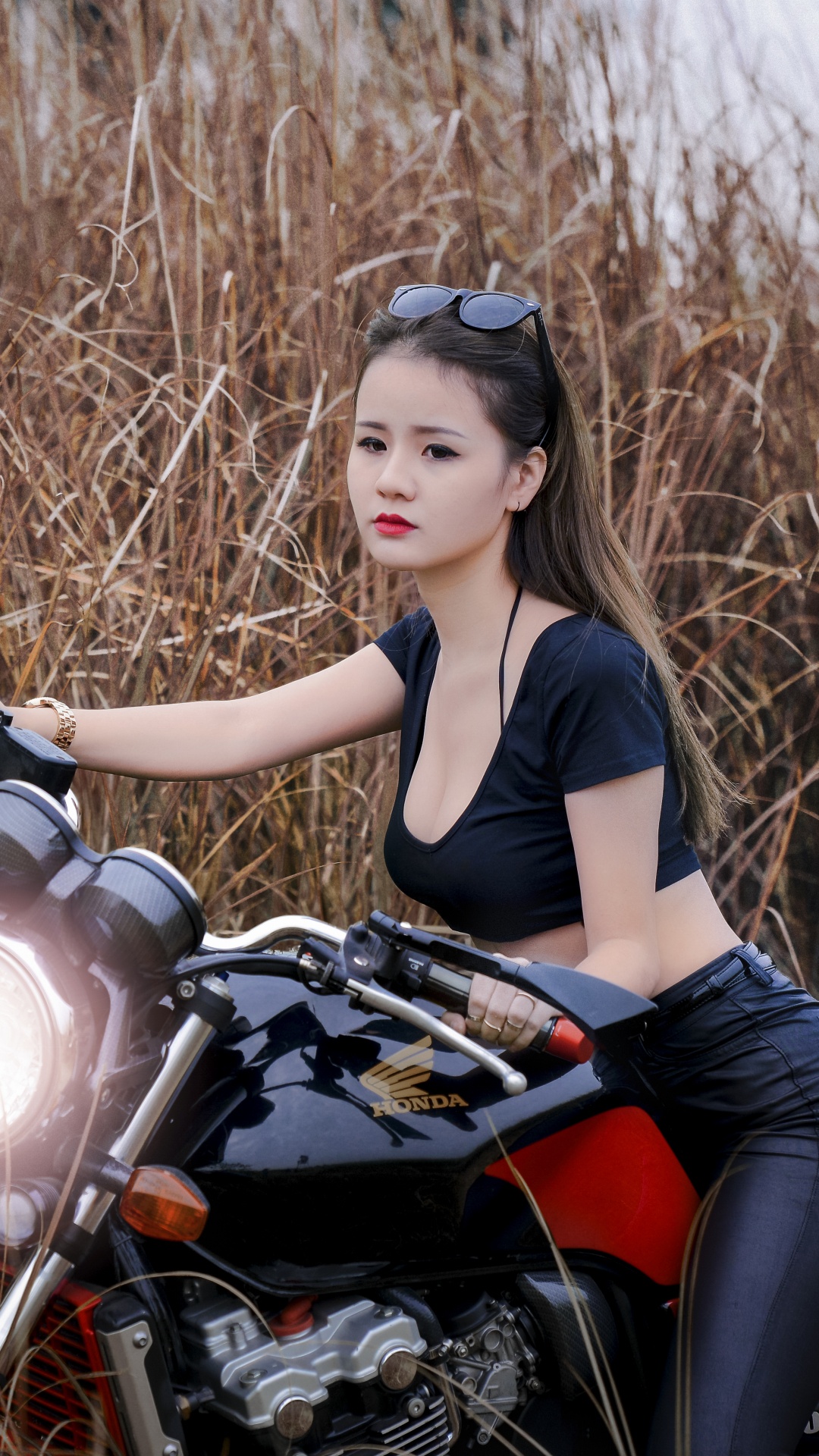 Woman in Black Tank Top and Black Leggings Sitting on Red and Black Motorcycle. Wallpaper in 1080x1920 Resolution