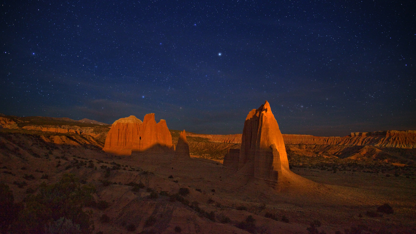 Brown Rock Formation Under Blue Sky During Night Time. Wallpaper in 1366x768 Resolution