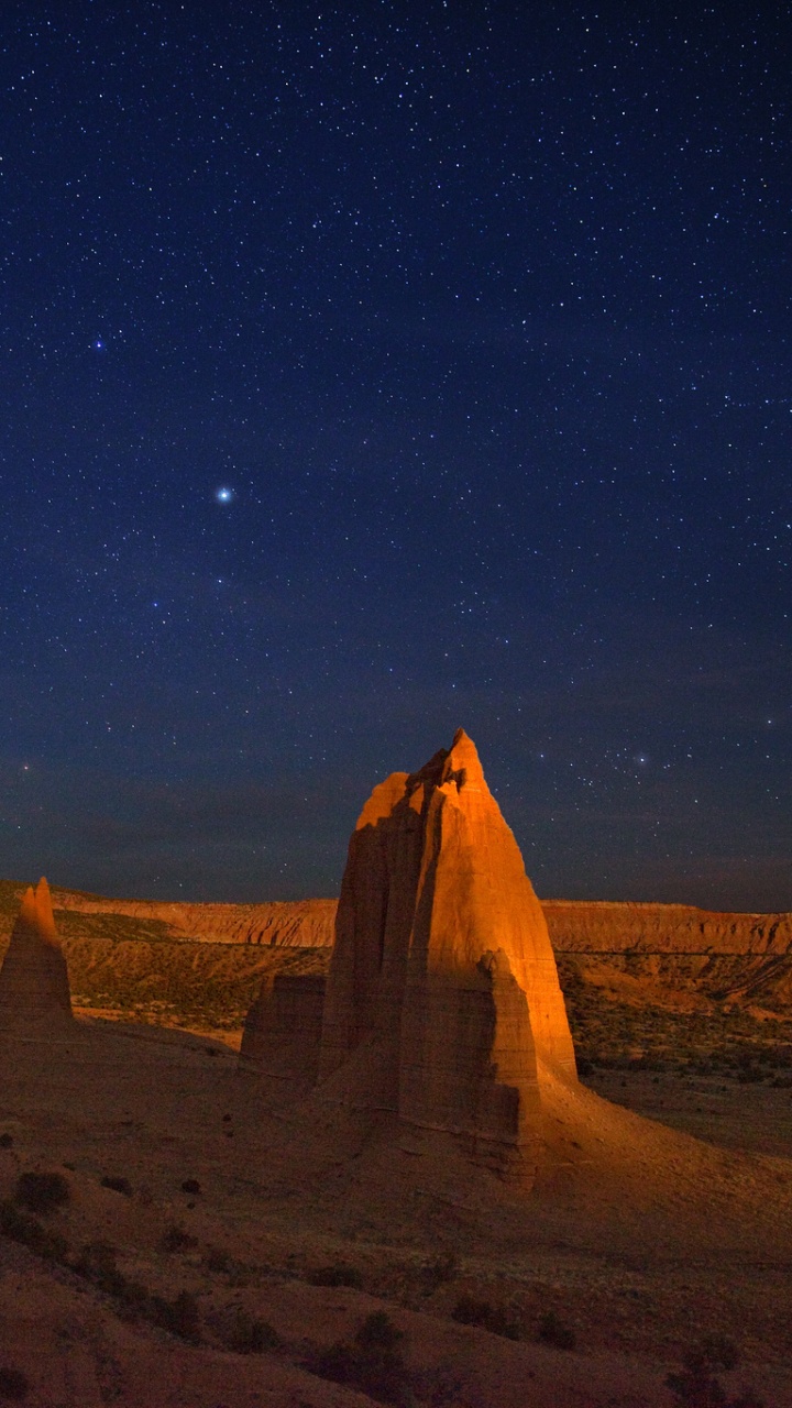 Brown Rock Formation Under Blue Sky During Night Time. Wallpaper in 720x1280 Resolution