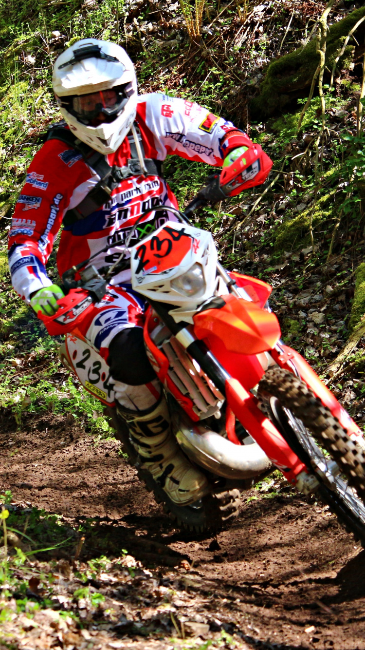 Man in Red and White Motocross Suit Riding Motocross Dirt Bike. Wallpaper in 750x1334 Resolution