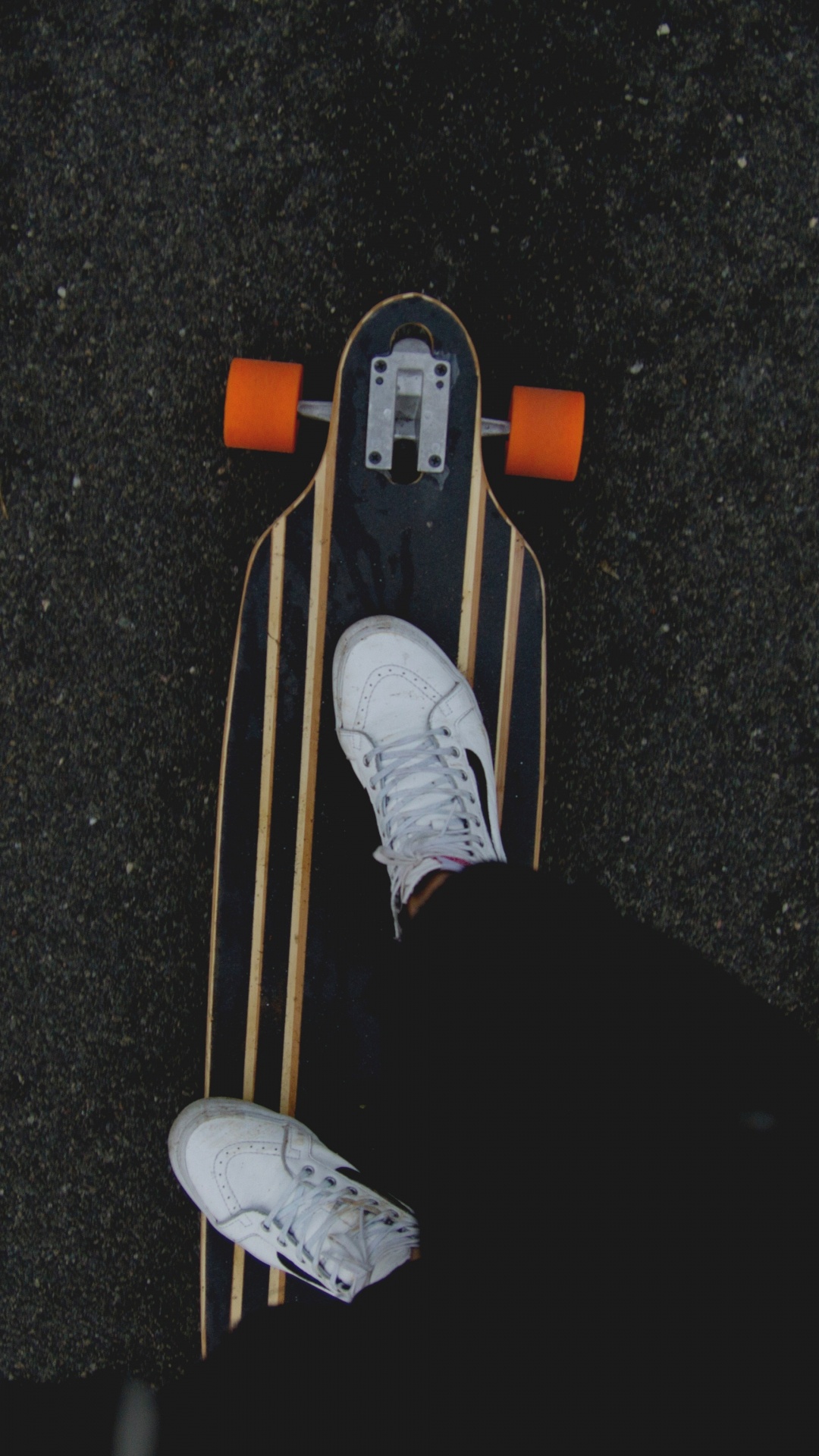 Person in Black Pants and White Sneakers Riding on Brown Wooden Skateboard. Wallpaper in 1080x1920 Resolution