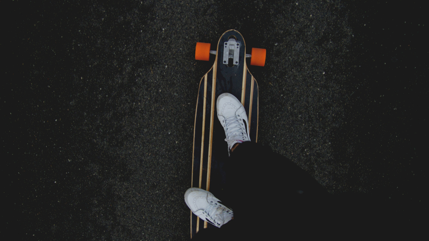 Person in Black Pants and White Sneakers Riding on Brown Wooden Skateboard. Wallpaper in 1366x768 Resolution