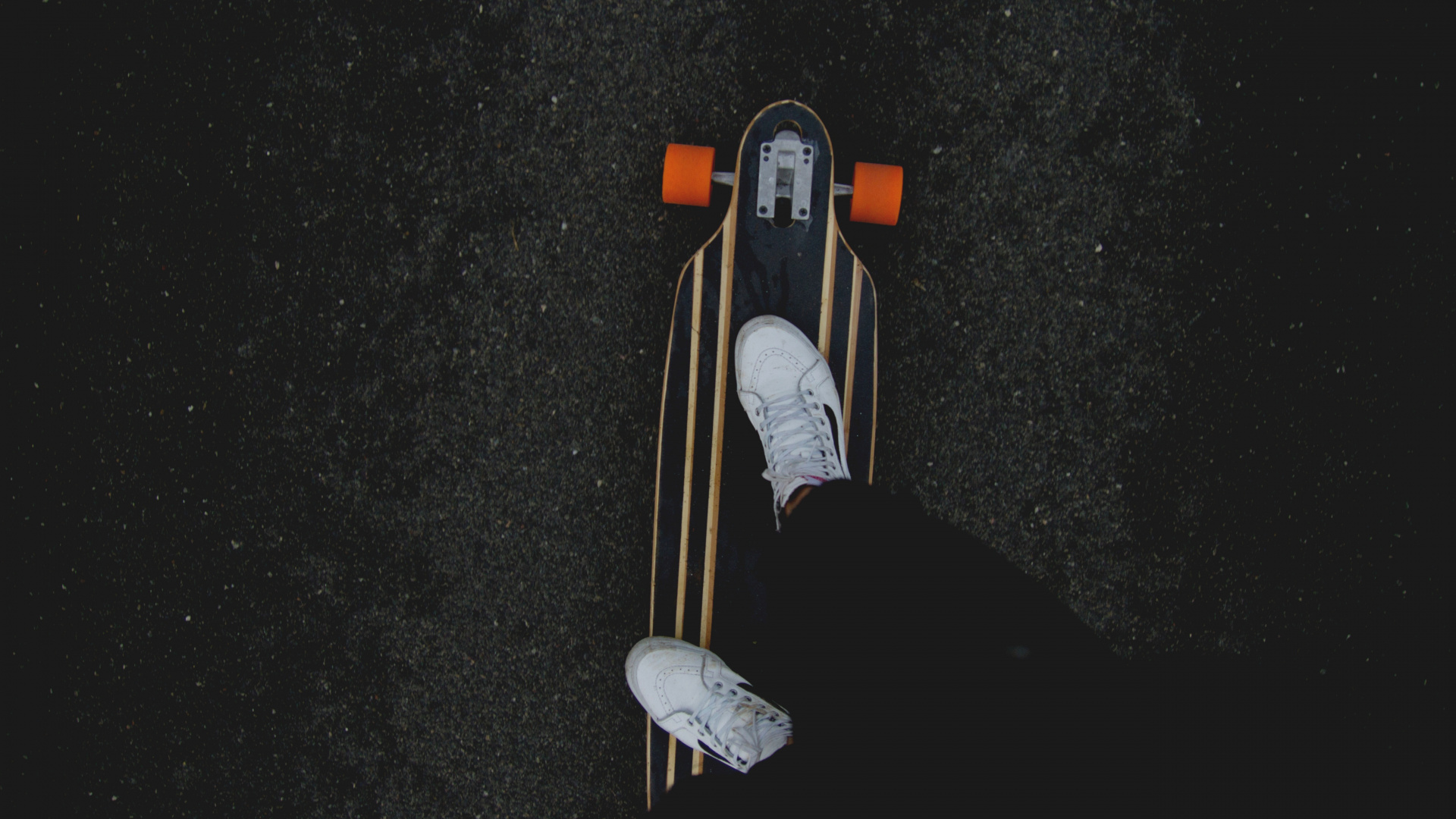 Person in Black Pants and White Sneakers Riding on Brown Wooden Skateboard. Wallpaper in 1920x1080 Resolution