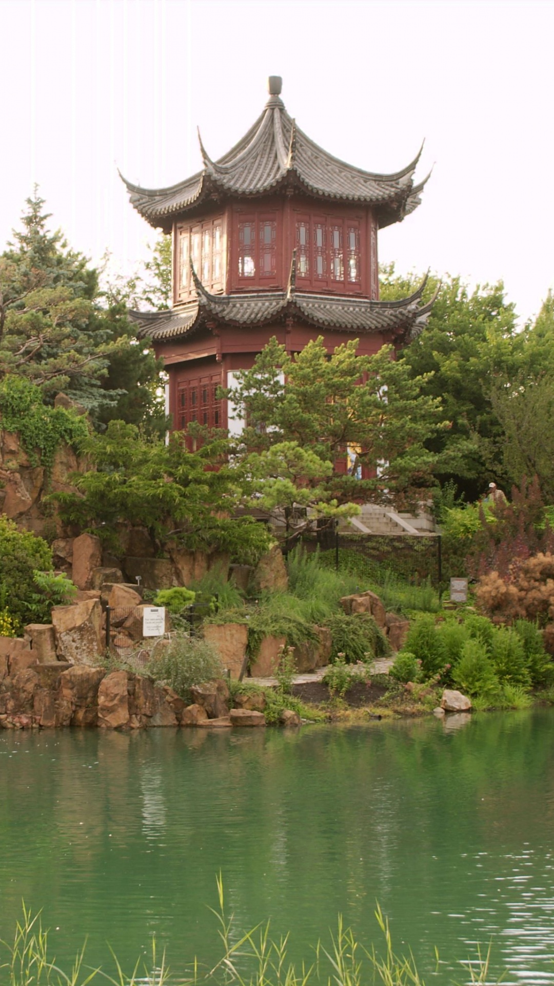 Brown and Red Temple Near Body of Water During Daytime. Wallpaper in 1080x1920 Resolution