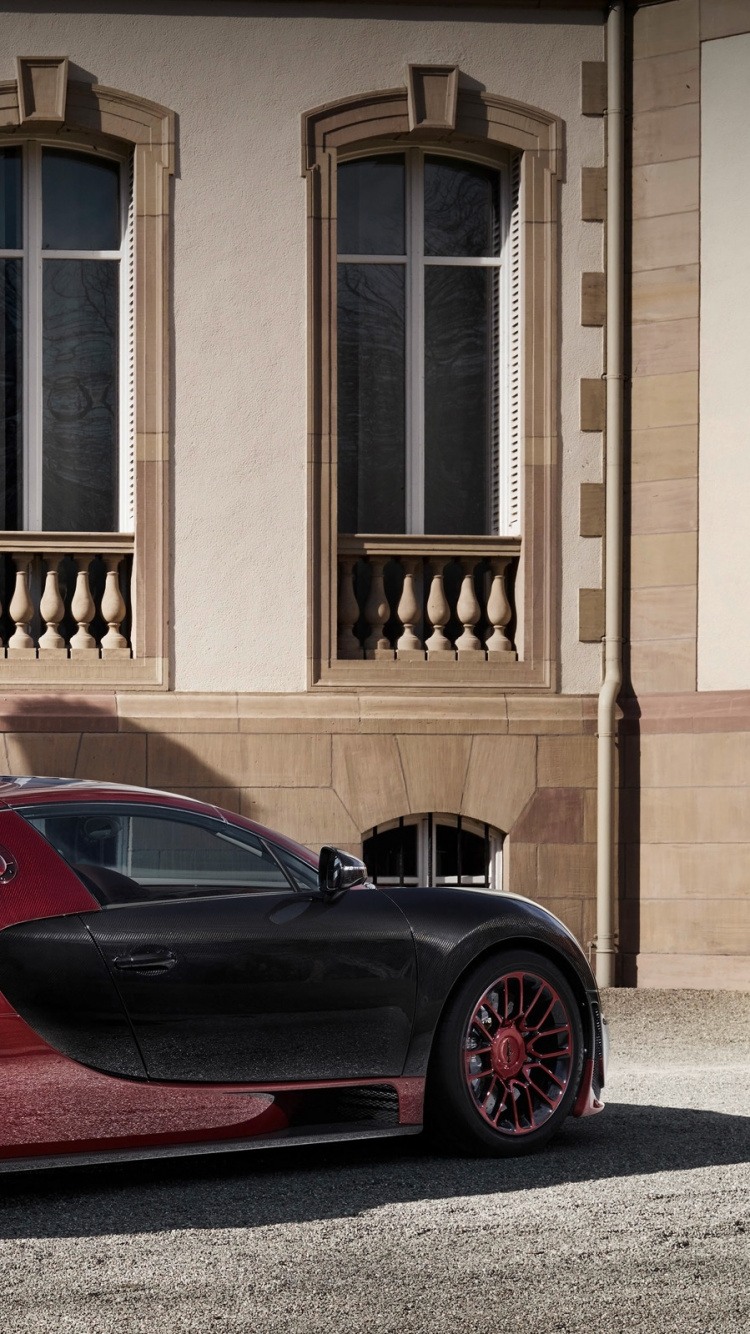 Red Ferrari 458 Italia Parked in Front of Brown Building. Wallpaper in 750x1334 Resolution