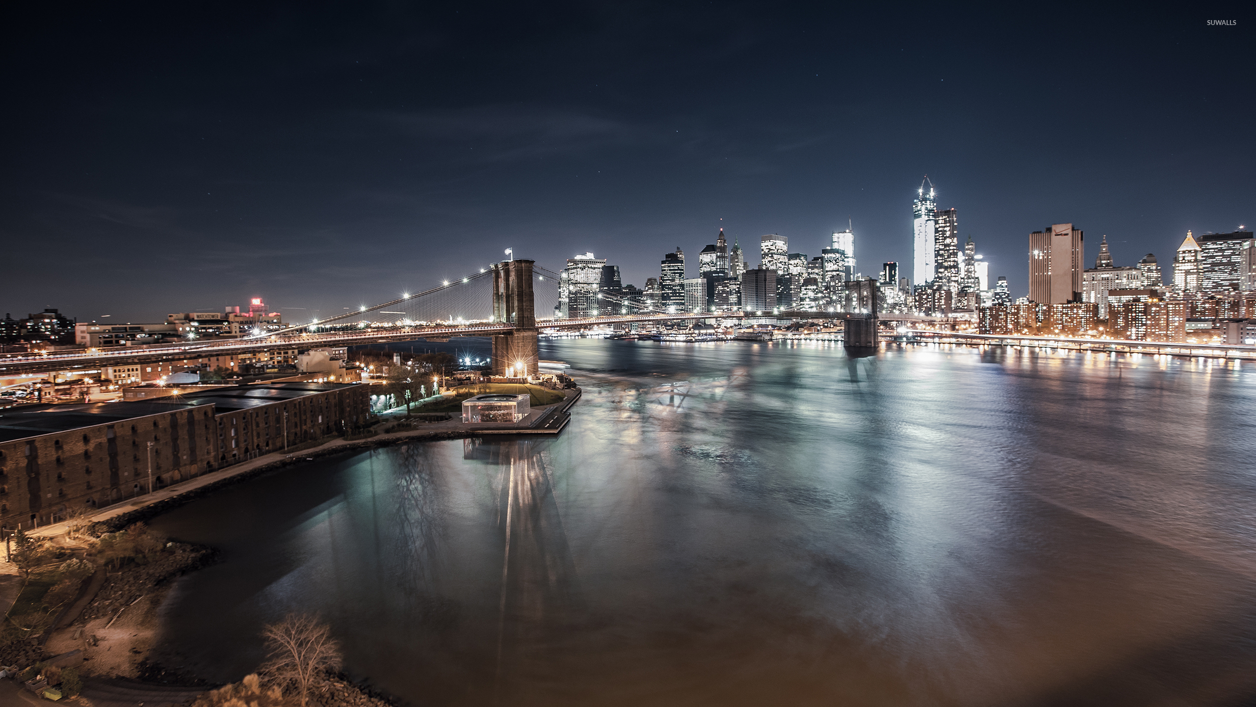 Bridge Over River Near City Buildings During Night Time. Wallpaper in 2560x1440 Resolution