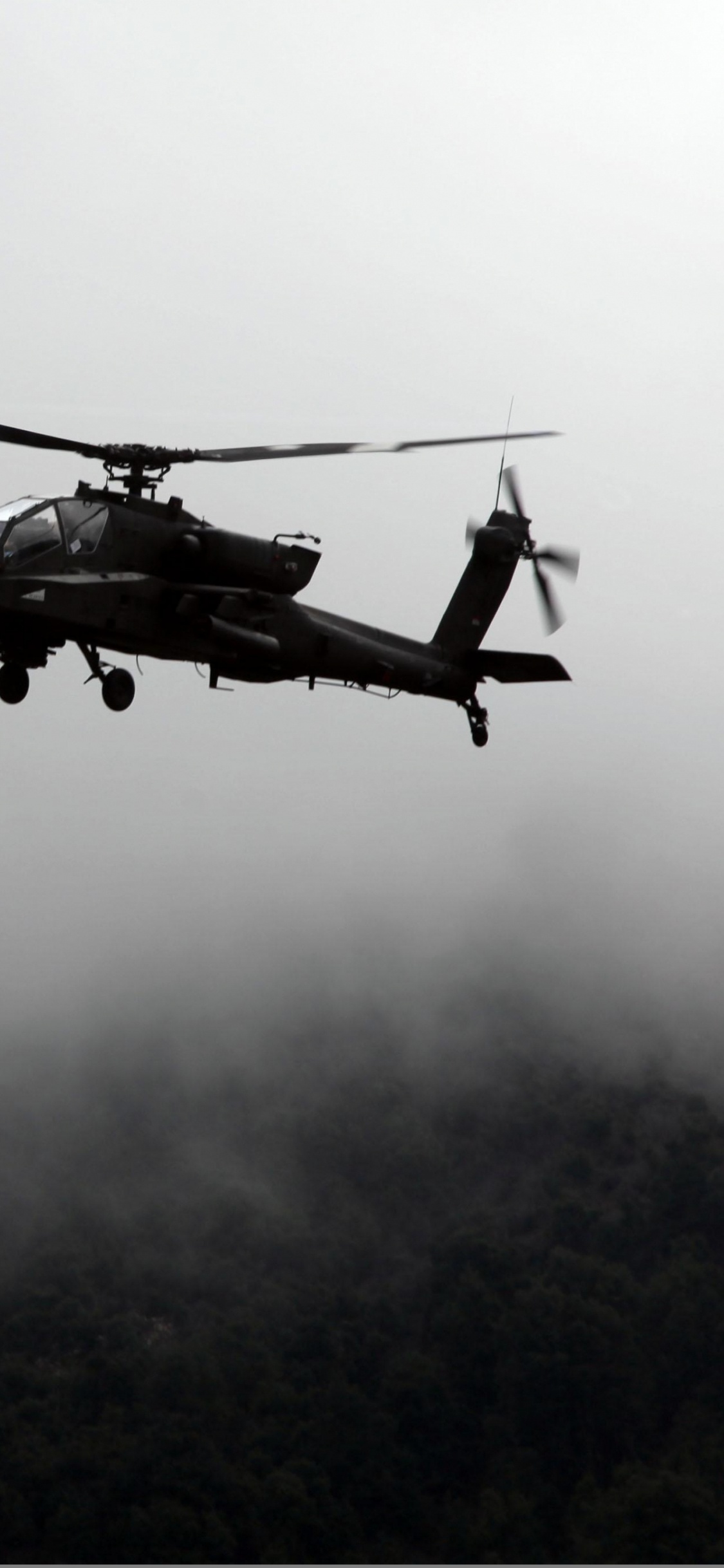 Helicóptero Negro Volando Sobre Las Nubes. Wallpaper in 1125x2436 Resolution