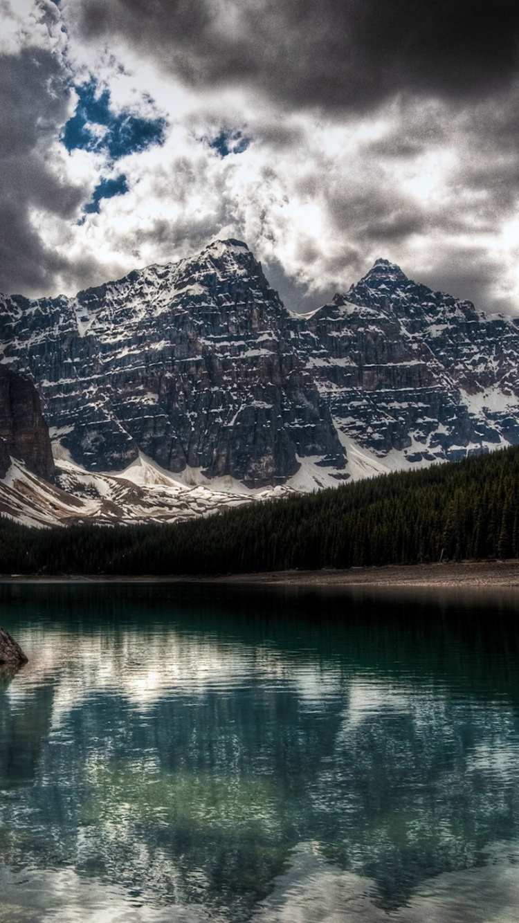 Lake Near Snow Covered Mountain Under Cloudy Sky During Daytime. Wallpaper in 750x1334 Resolution