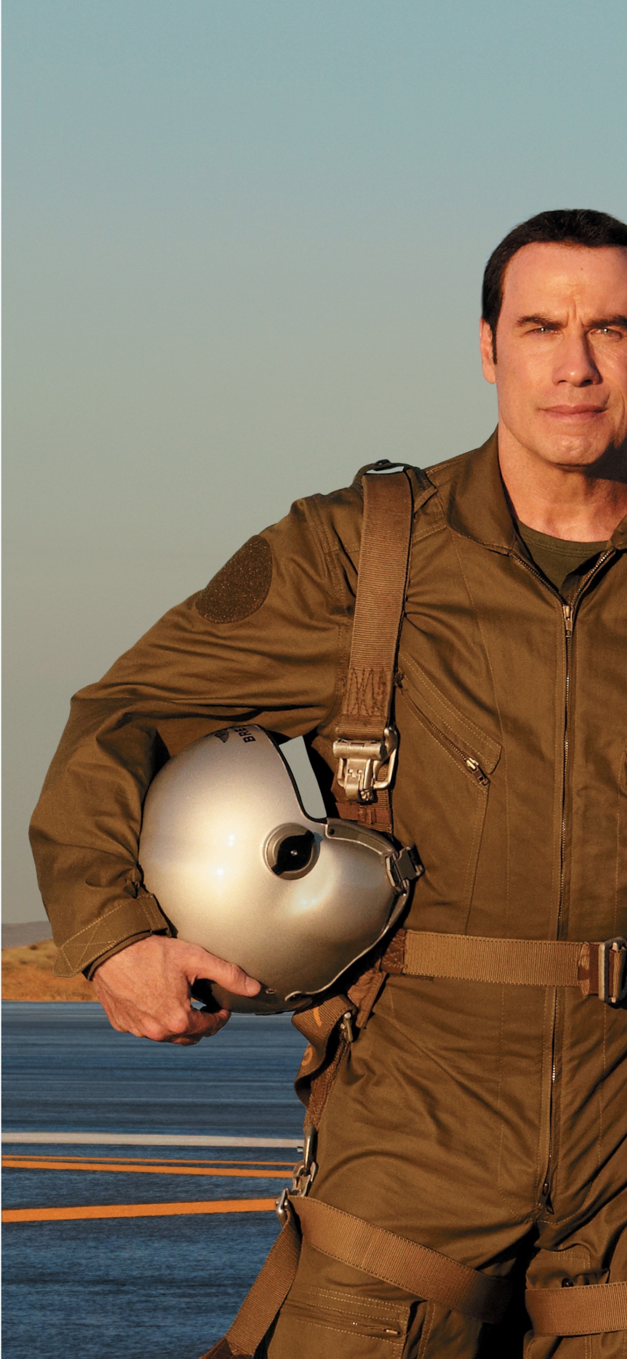 Mann in Brauner Jacke Steht Neben Grauem Und Orangefarbenem Flugzeug. Wallpaper in 1242x2688 Resolution