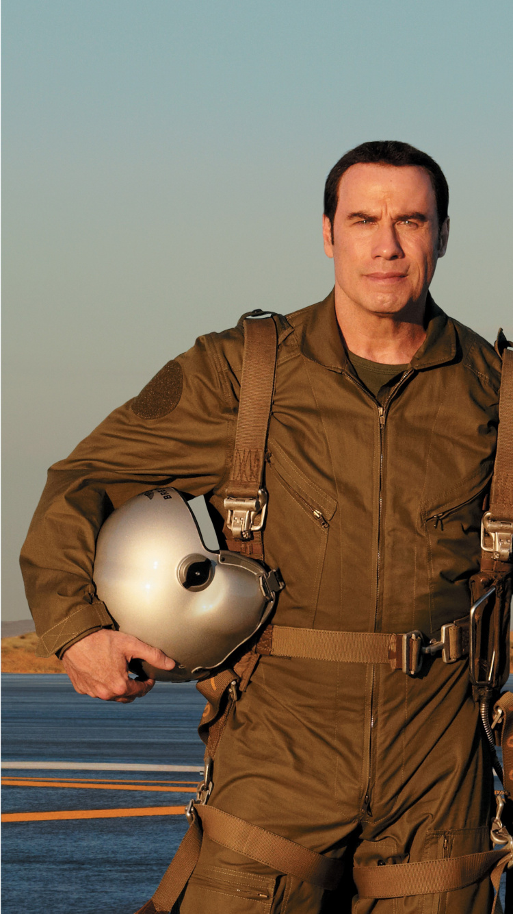 Hombre de Chaqueta Marrón de Pie Junto al Avión Gris y Naranja. Wallpaper in 750x1334 Resolution