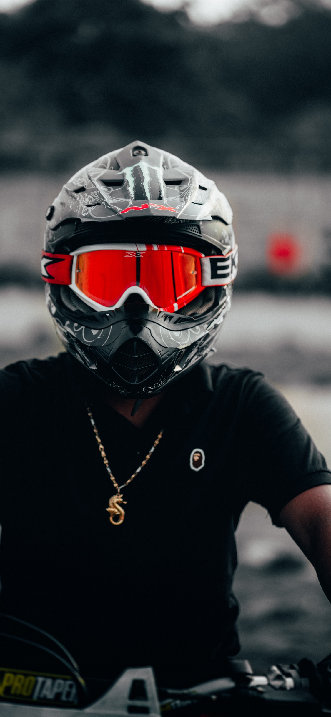 Person Wearing Black and Red Helmet. Wallpaper in 1125x2436 Resolution